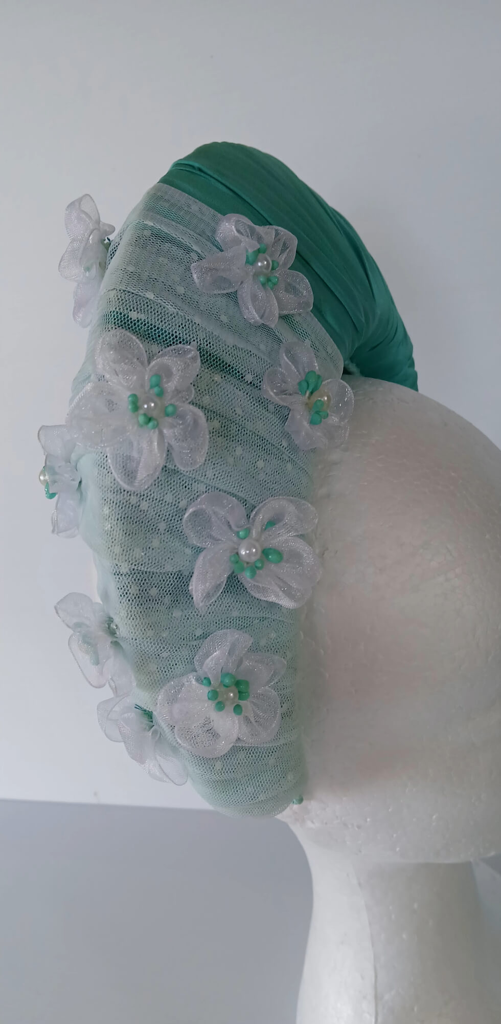 A picture of a Green Blocked Millinery Crown by Melissa Rath Millinery.