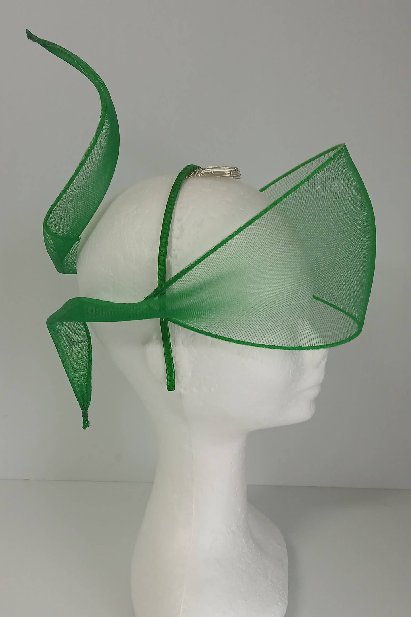 A picture of a green crinoline veil with Swirls by Melissa Rath Millinery