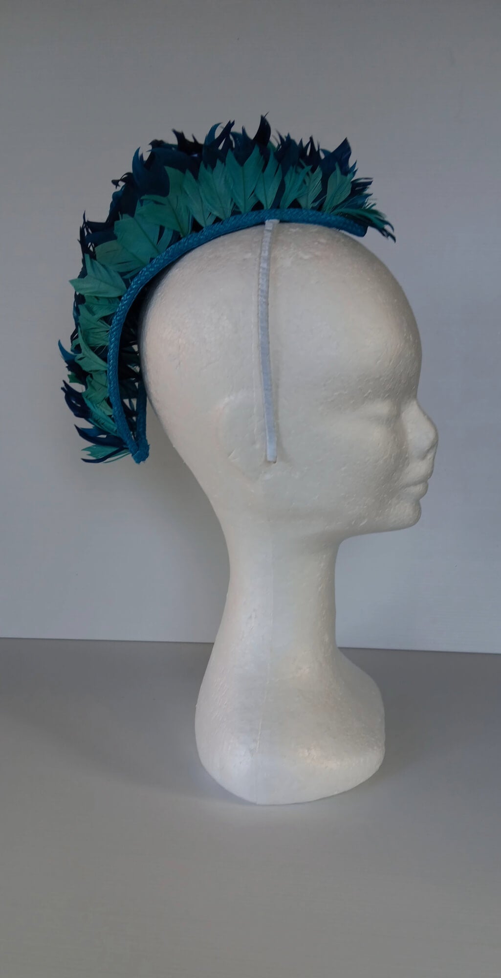 A picture of a Blue and Green Feathered Millinery Mohawk by Melissa Rath Millinery.