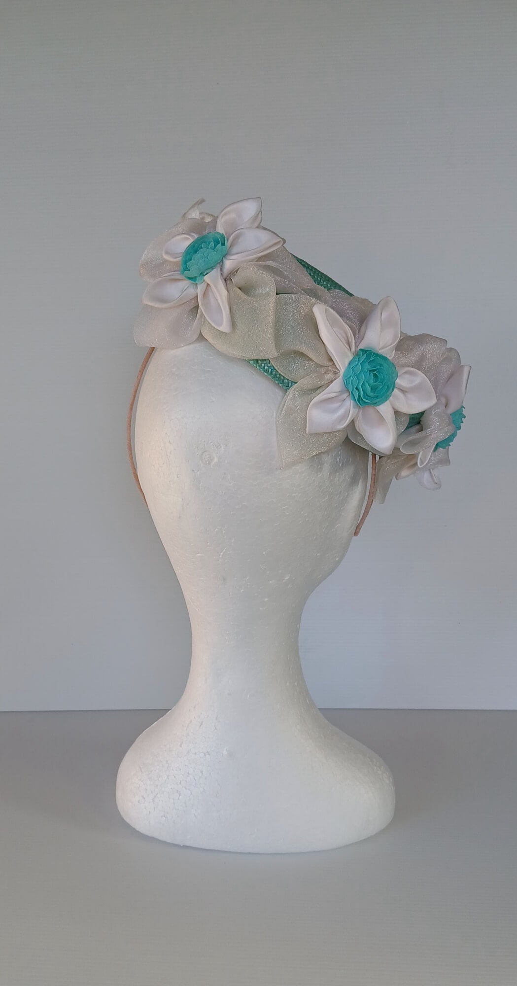 A picture of a Green Millinery Pillbox Hat with white velvet trim by Melissa Rath Millinery.