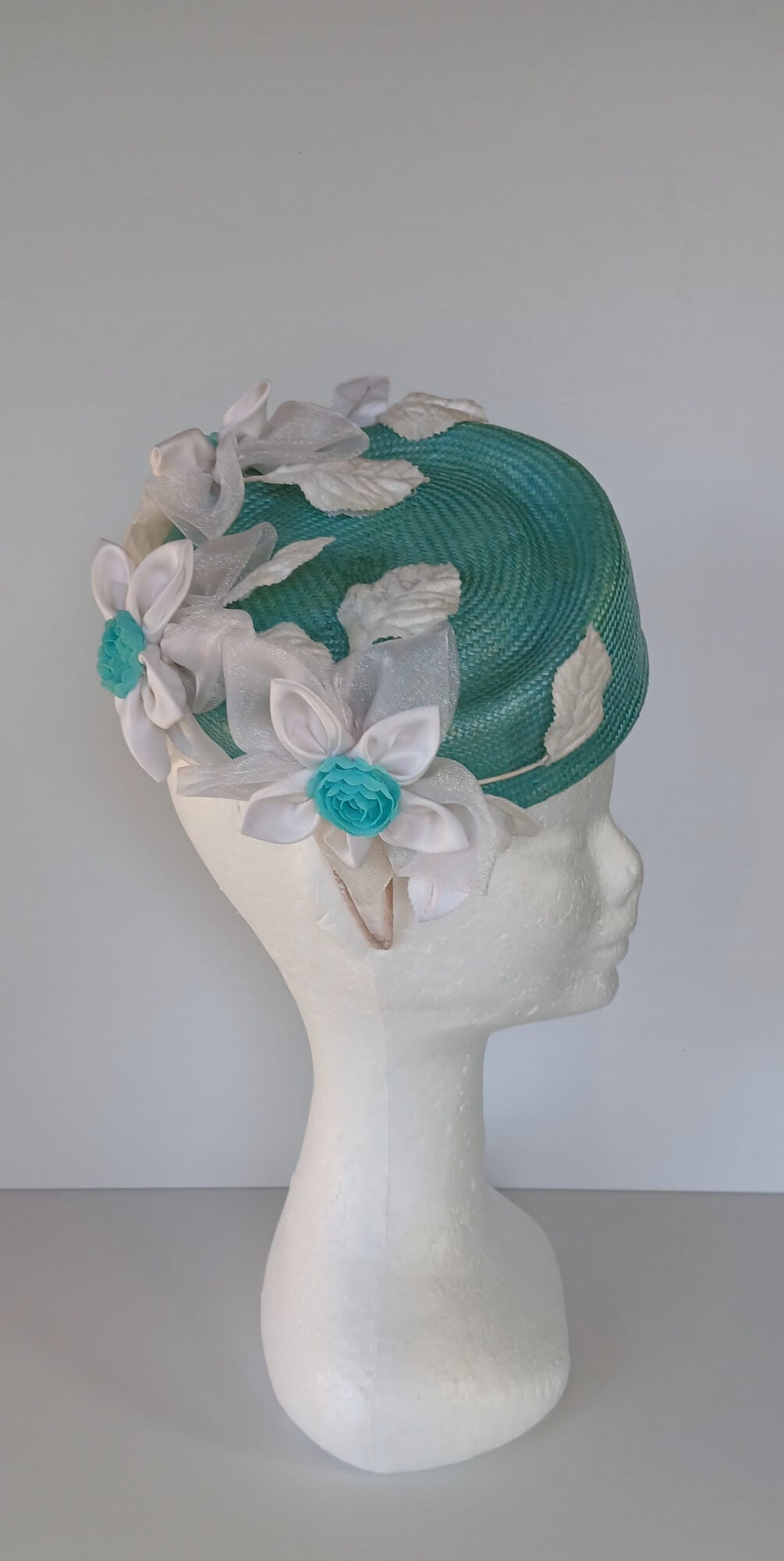 A picture of a Green Millinery Pillbox Hat with white velvet trim by Melissa Rath Millinery.