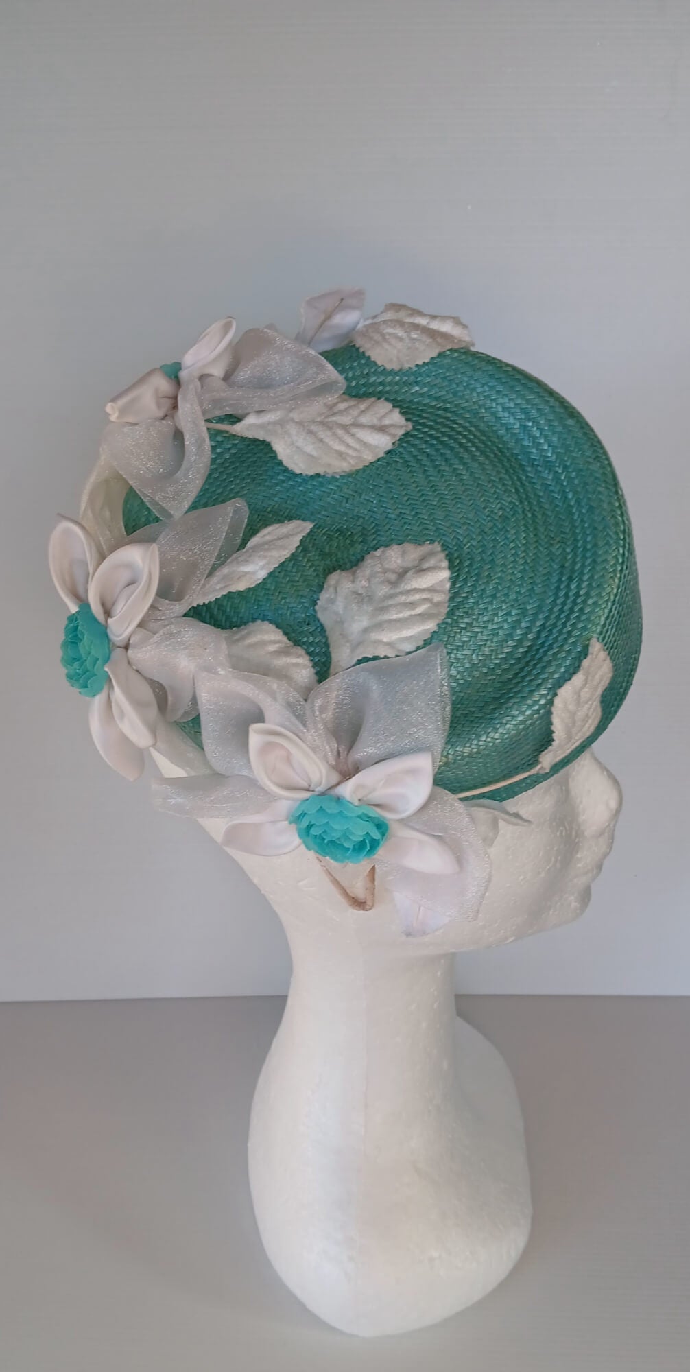 A picture of a Green Millinery Pillbox Hat with white velvet trim by Melissa Rath Millinery.