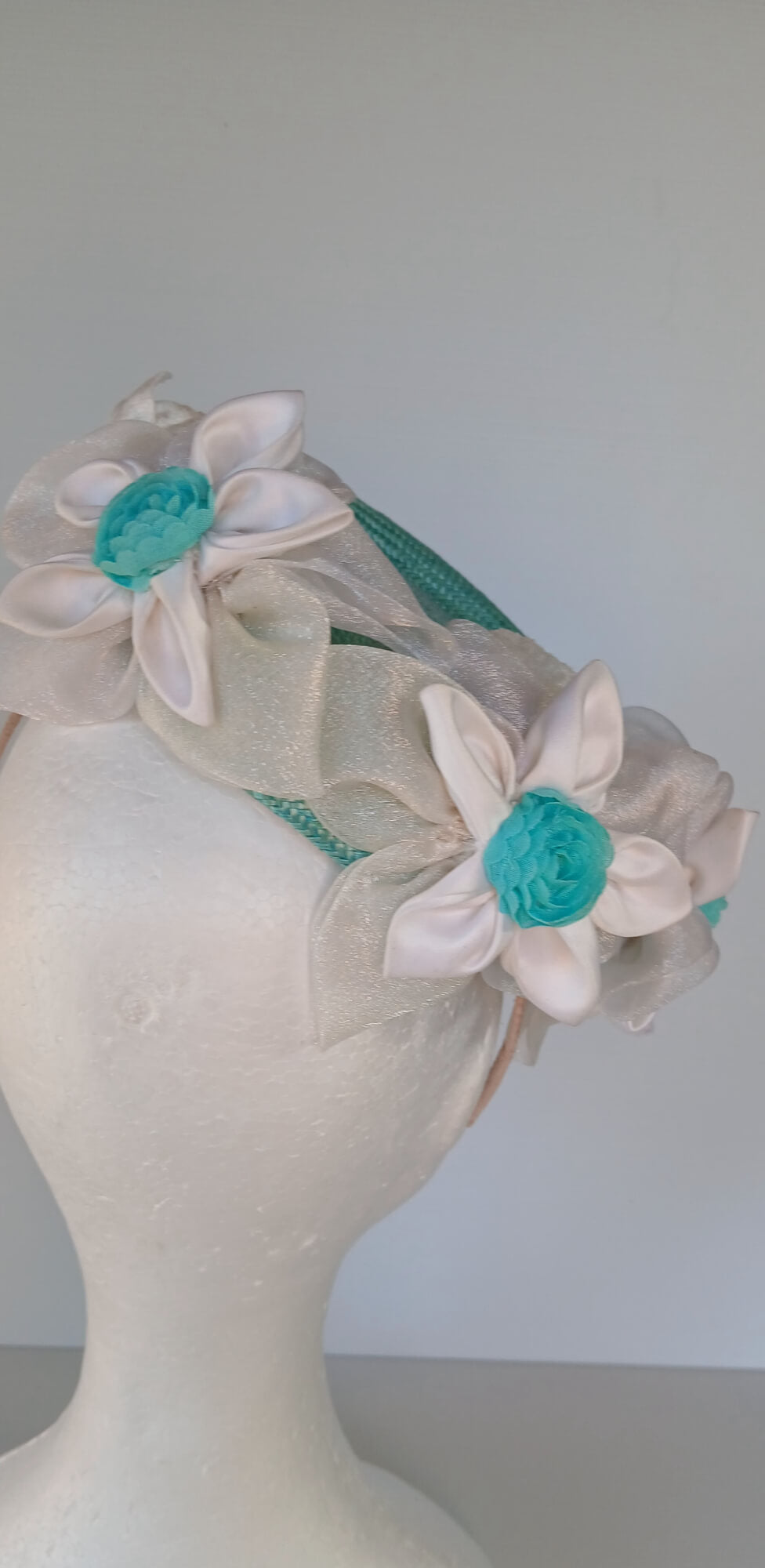 A picture of a Green Millinery Pillbox Hat with white velvet trim by Melissa Rath Millinery.