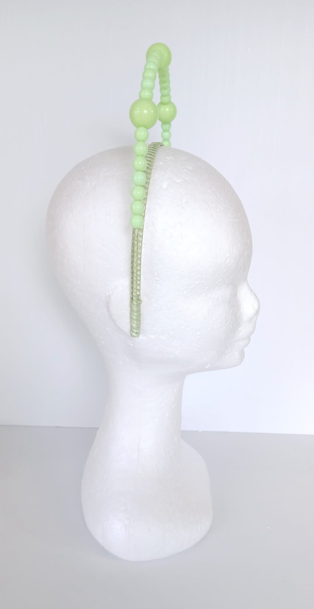 A picture of a Green Beaded Millinery Headband by Melissa Rath Millinery.