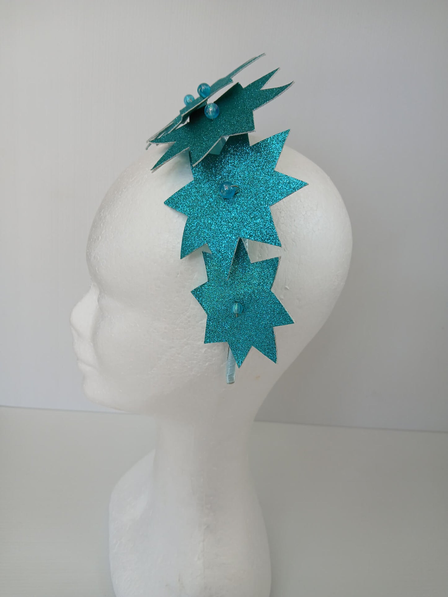A picture of a Green Pleather Millinery Headband by Melissa Rath Millinery.