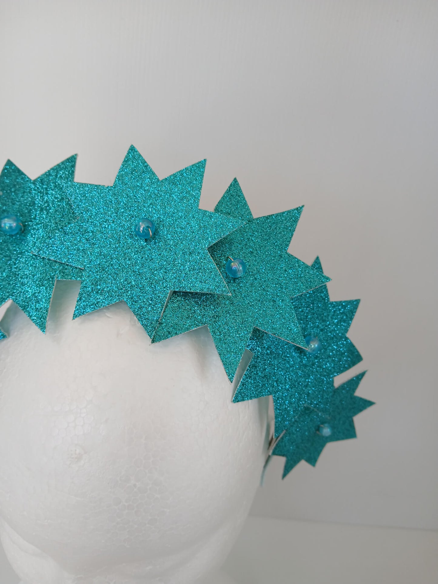 A picture of a Green Pleather Millinery Headband by Melissa Rath Millinery.