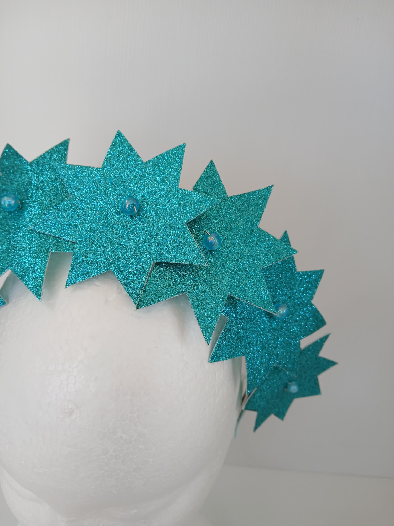 A picture of a Green Pleather Millinery Headband by Melissa Rath Millinery.