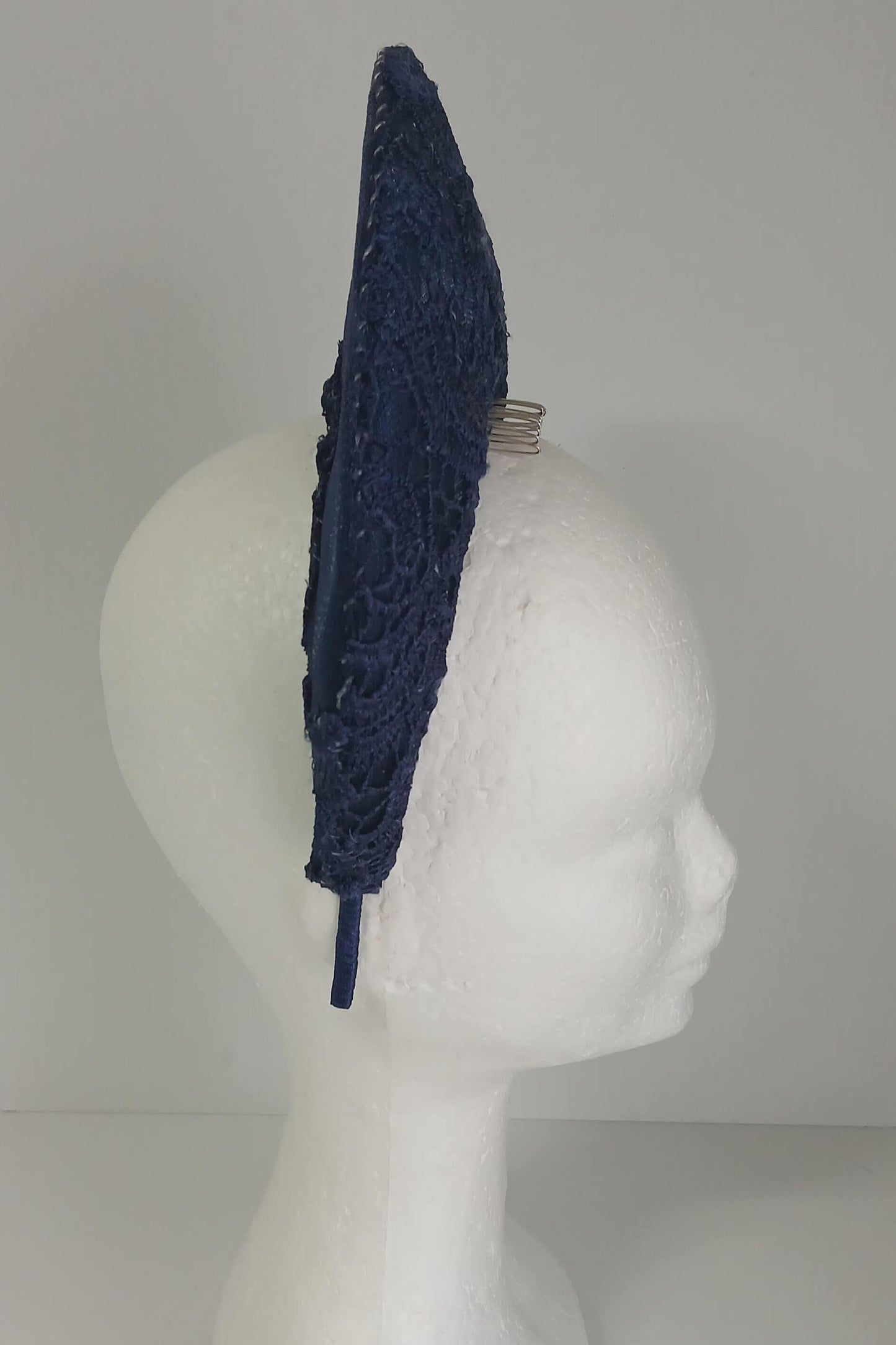 A navy millinery crown by Melissa Rath Millinery, made from crinoline and with a lace overlay.