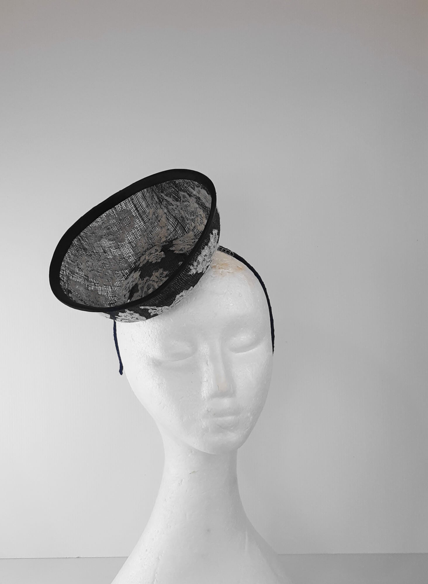 A picture of a Navy and White Saucer Hat by Melissa Rath Millinery.