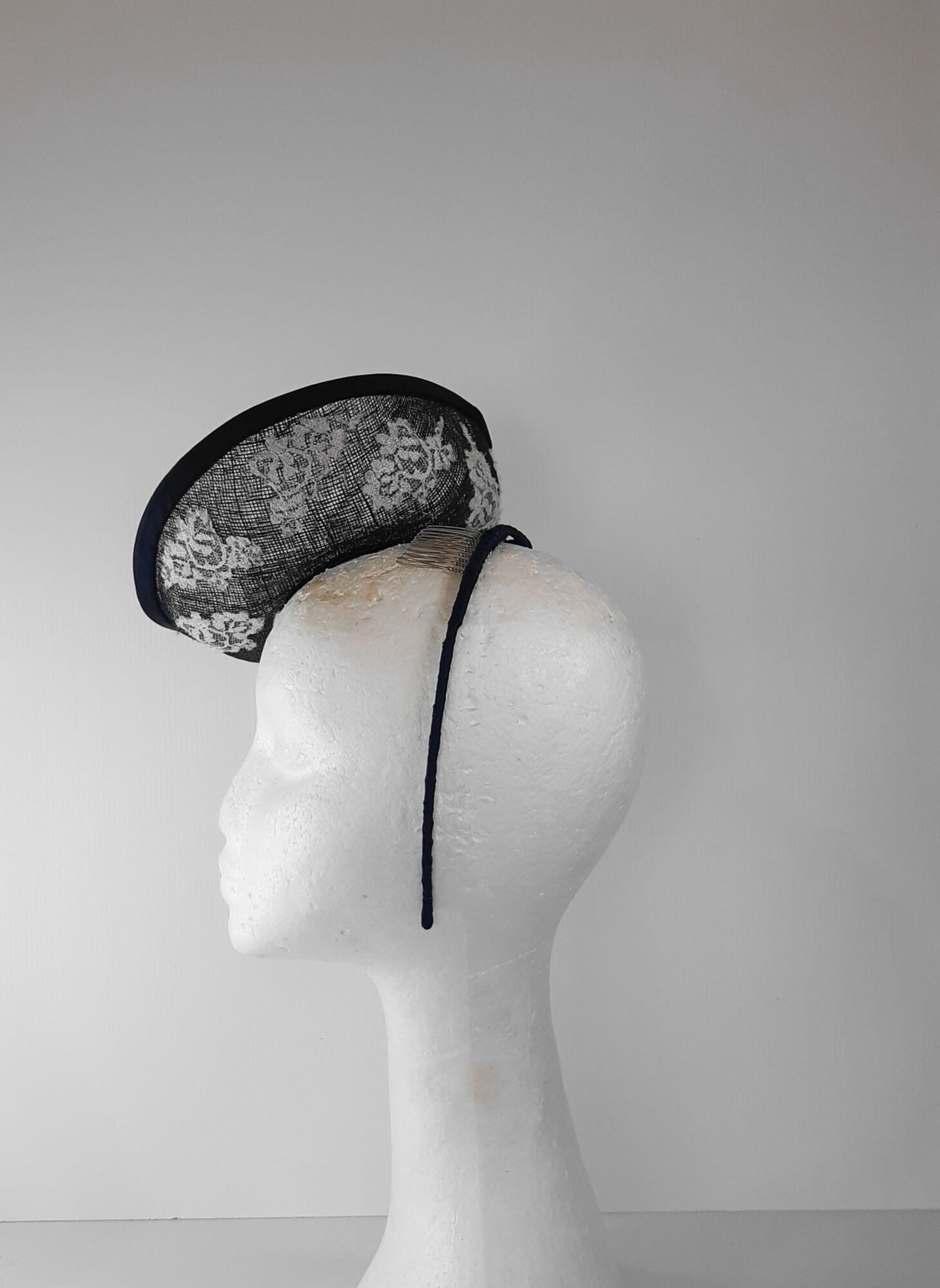 A picture of a Navy and White Saucer Hat by Melissa Rath Millinery.
