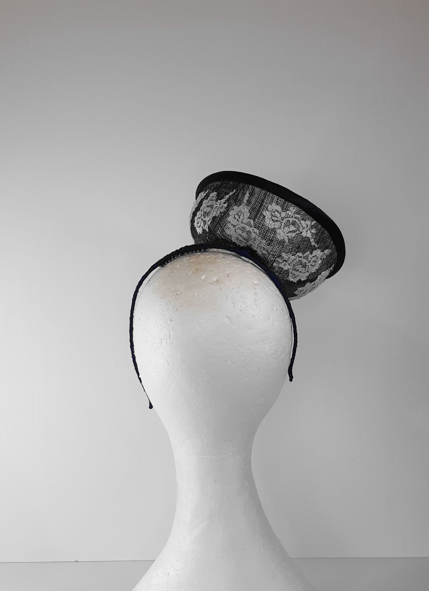 A picture of a Navy and White Saucer Hat by Melissa Rath Millinery.