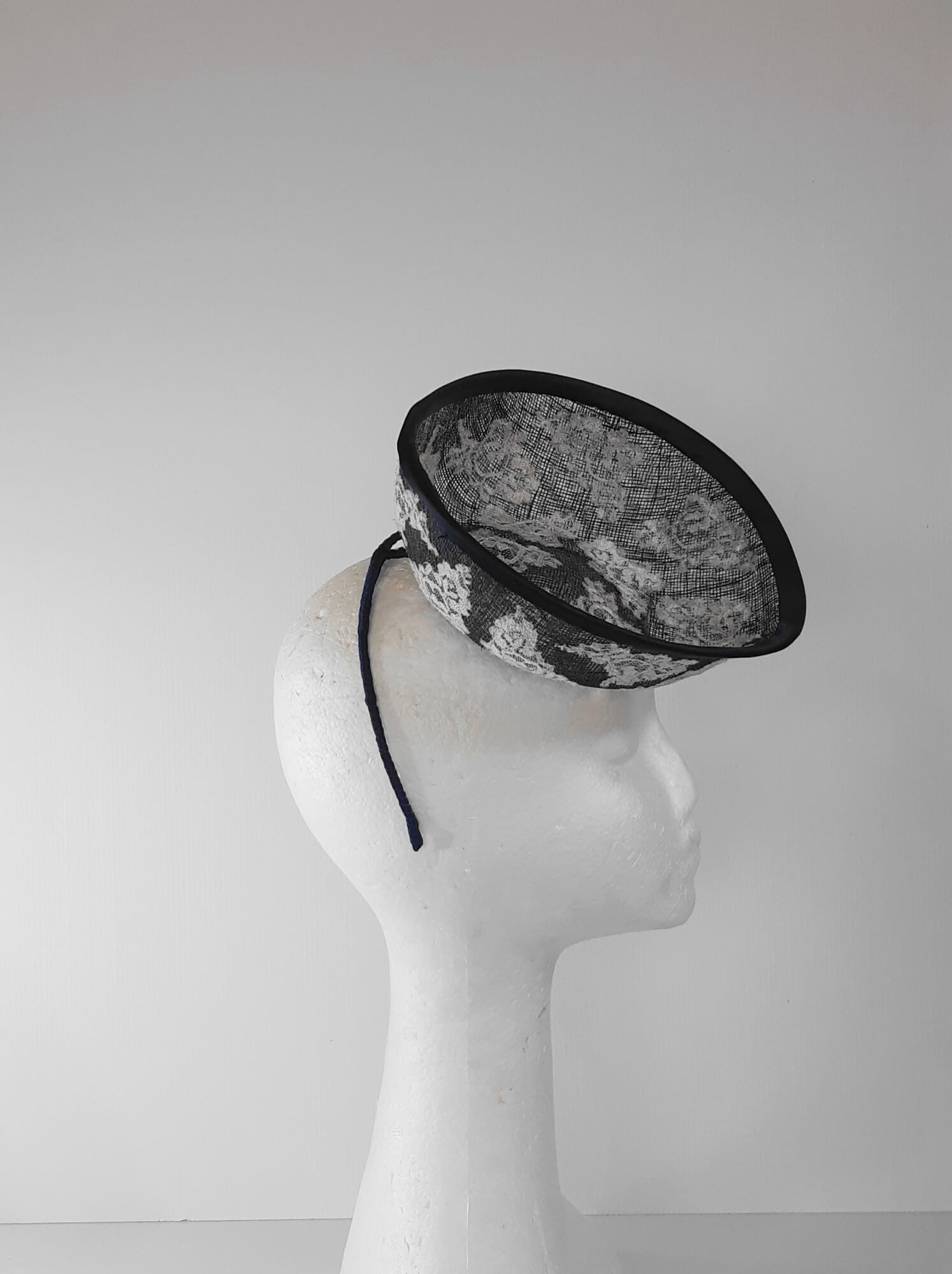 A picture of a Navy and White Saucer Hat by Melissa Rath Millinery.