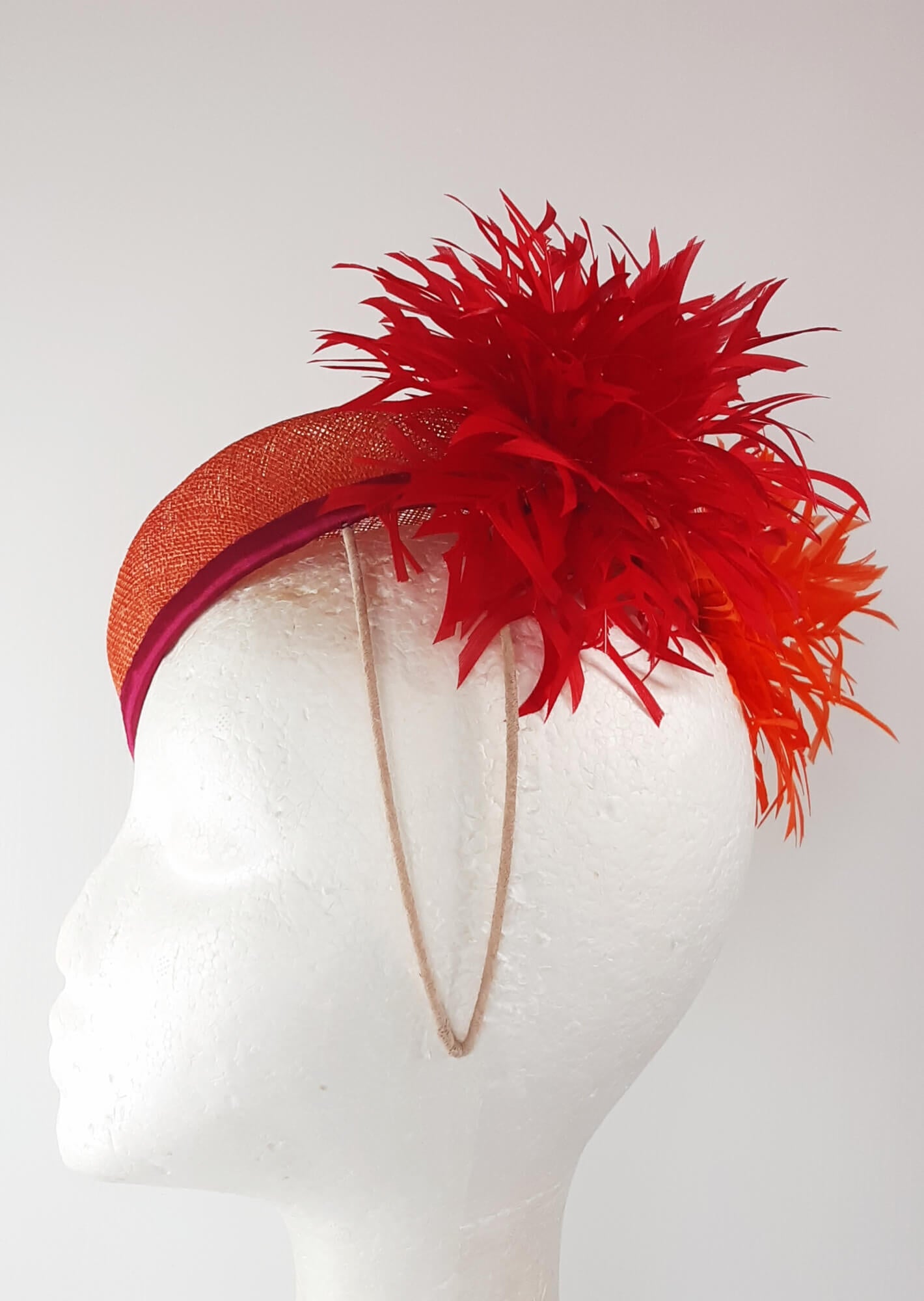 A picture of an Orange, Red and Yellow Millinery Pillbox Hat by Melissa Rath Millinery.