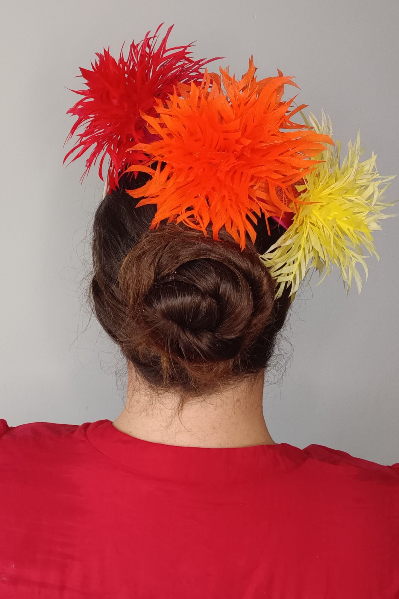 A picture of an Orange, Red and Yellow Millinery Pillbox Hat by Melissa Rath Millinery.