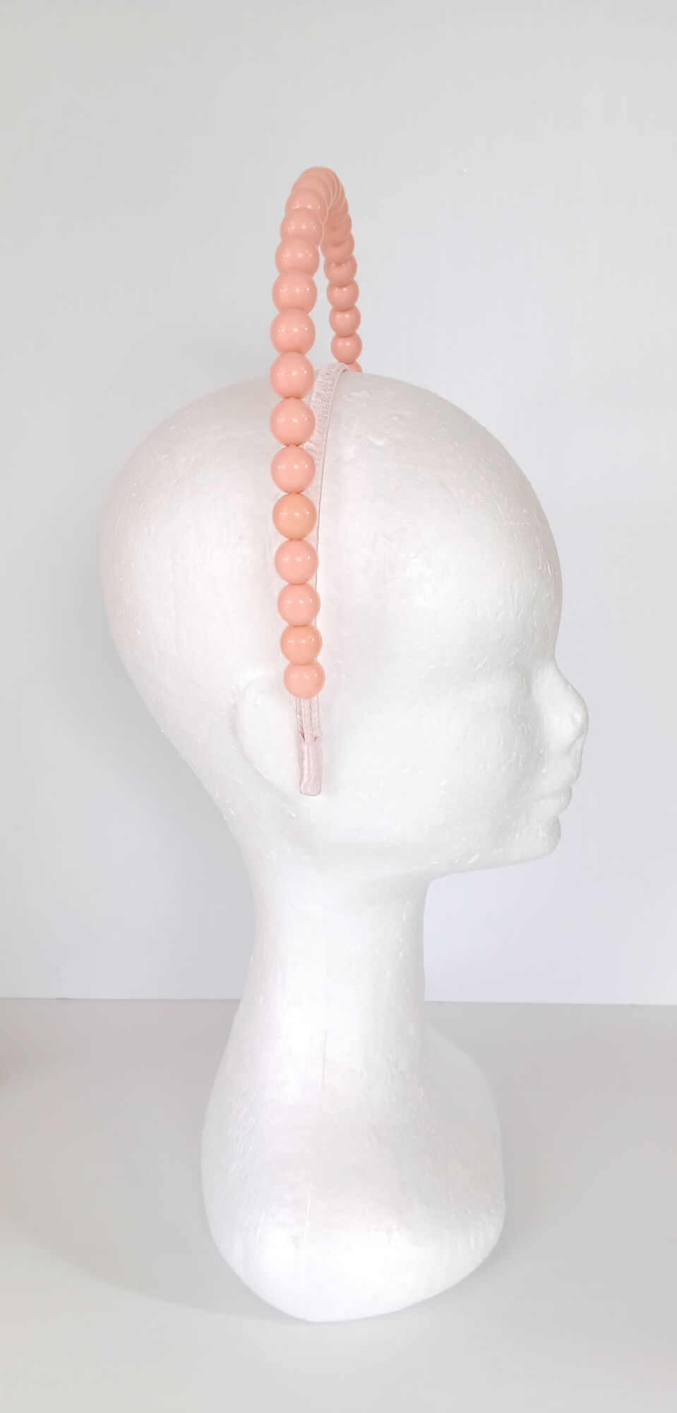 A picture of an Apricot Beaded Headband by Melissa Rath Millinery.