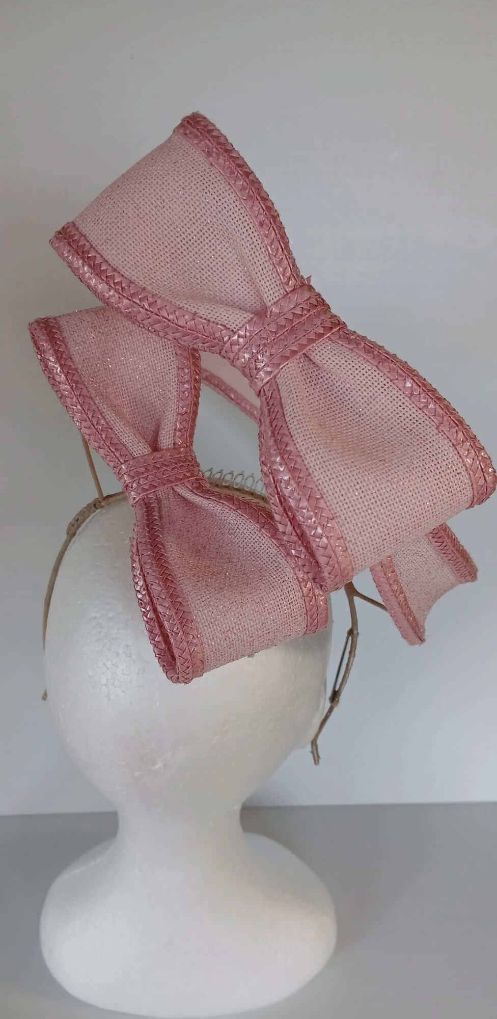 A picture of a Pink Bow Floating Headpiece by Melissa Rath Millinery