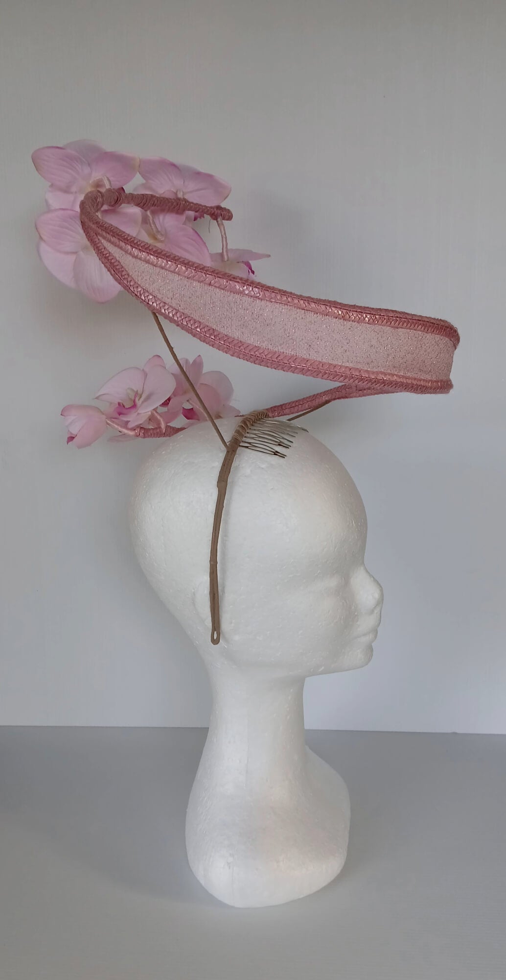 A picture of a Pink Orchid Floating Headpiece by Melissa Rath Millinery