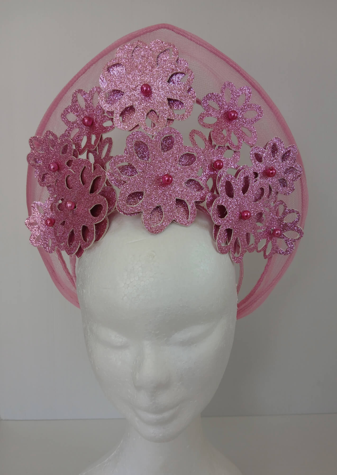 A picture of a Pink Pleather Millinery Halo Crown by Melissa Rath Millinery