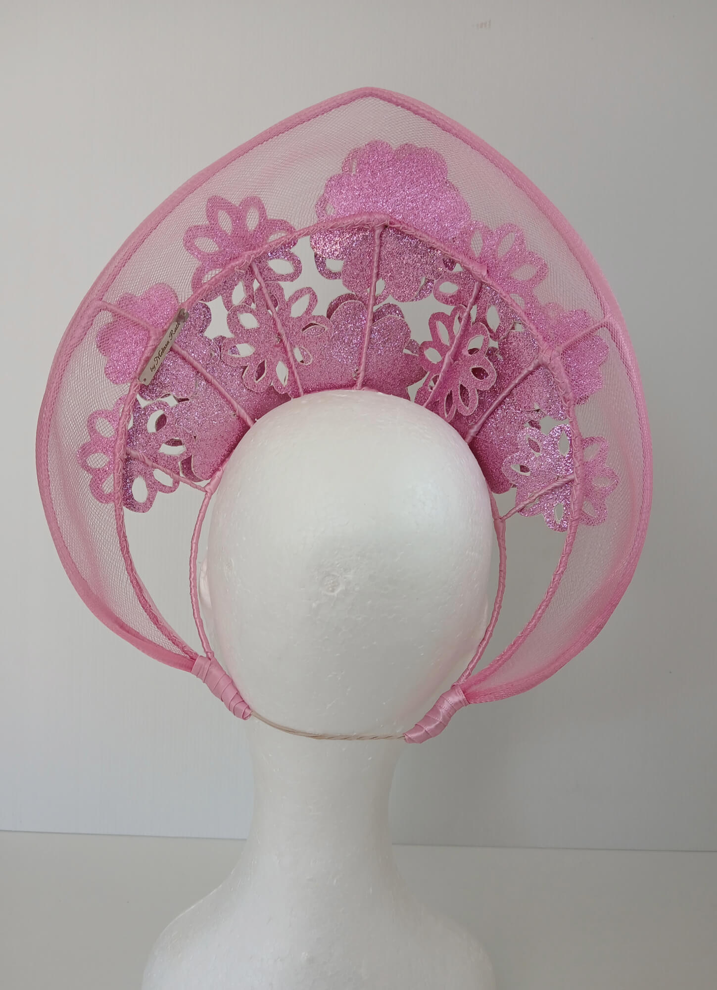 A picture of a Pink Pleather Millinery Halo Crown by Melissa Rath Millinery