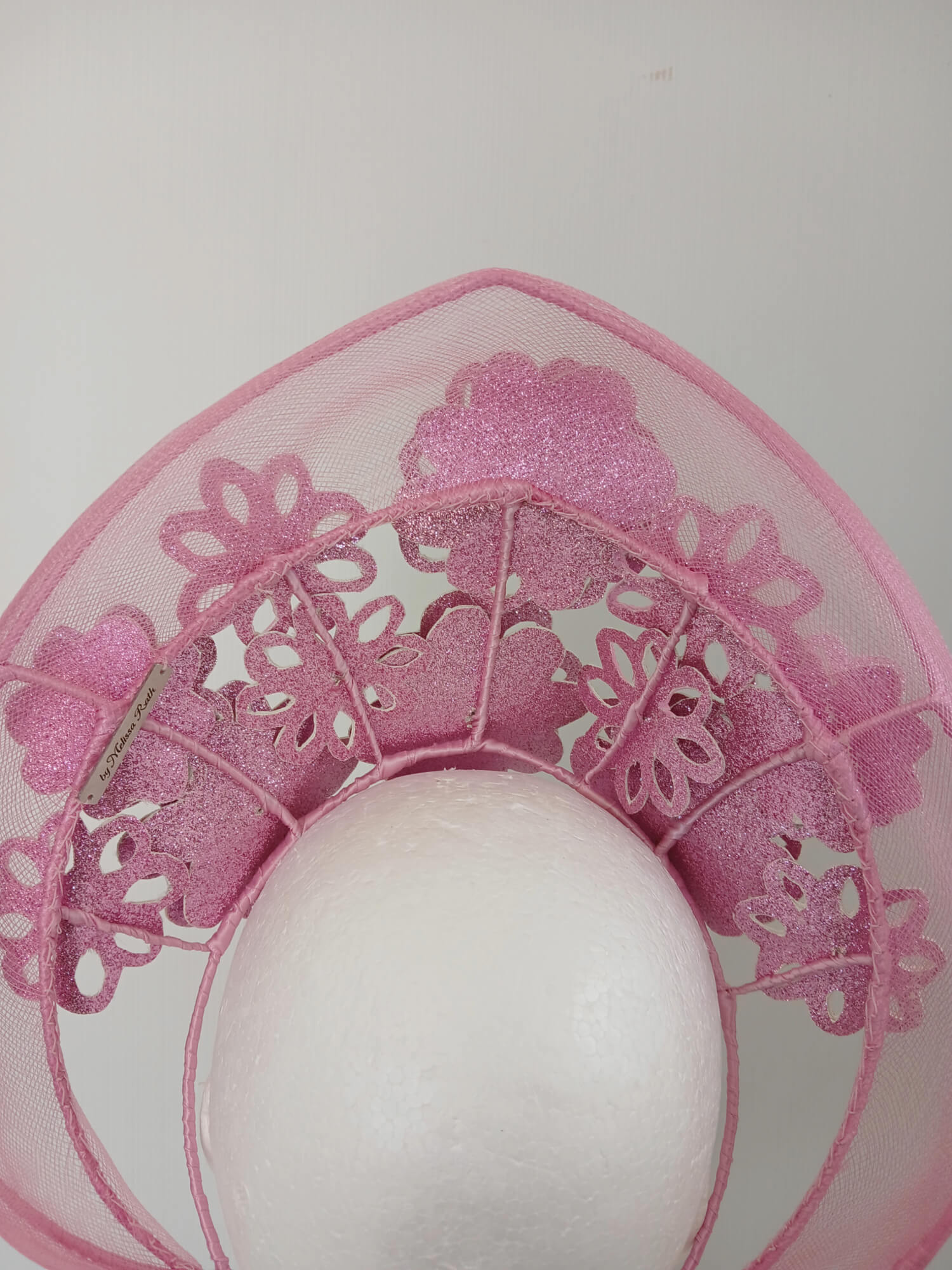 A picture of a Pink Pleather Millinery Halo Crown by Melissa Rath Millinery