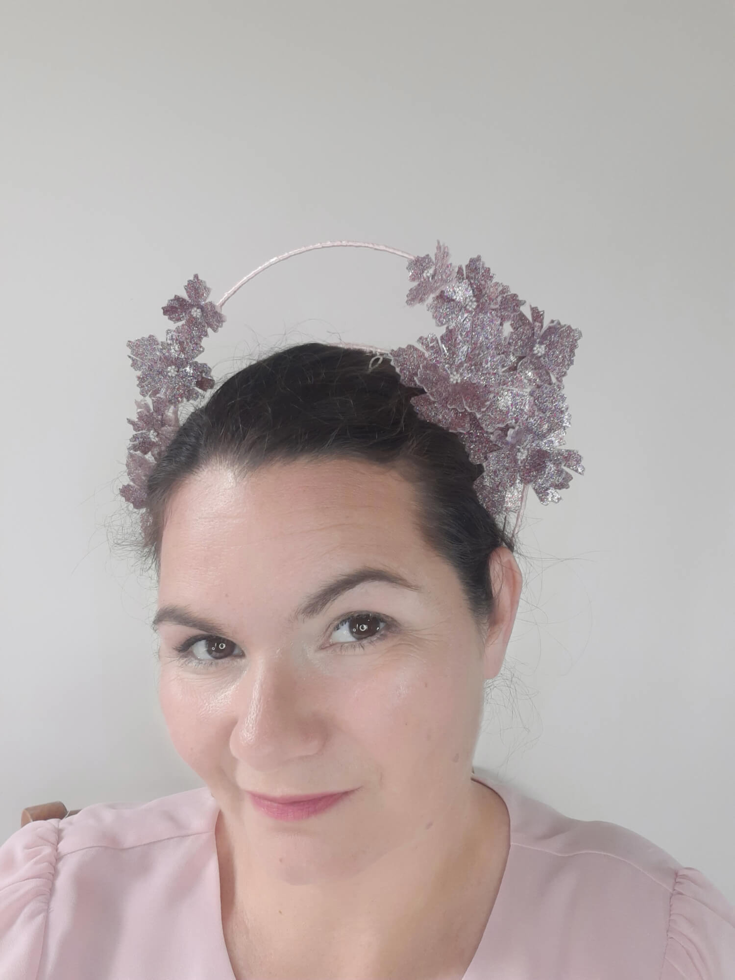A picture of a Pink Pleather Millinery Halo Crown by Melissa Rath Millinery.