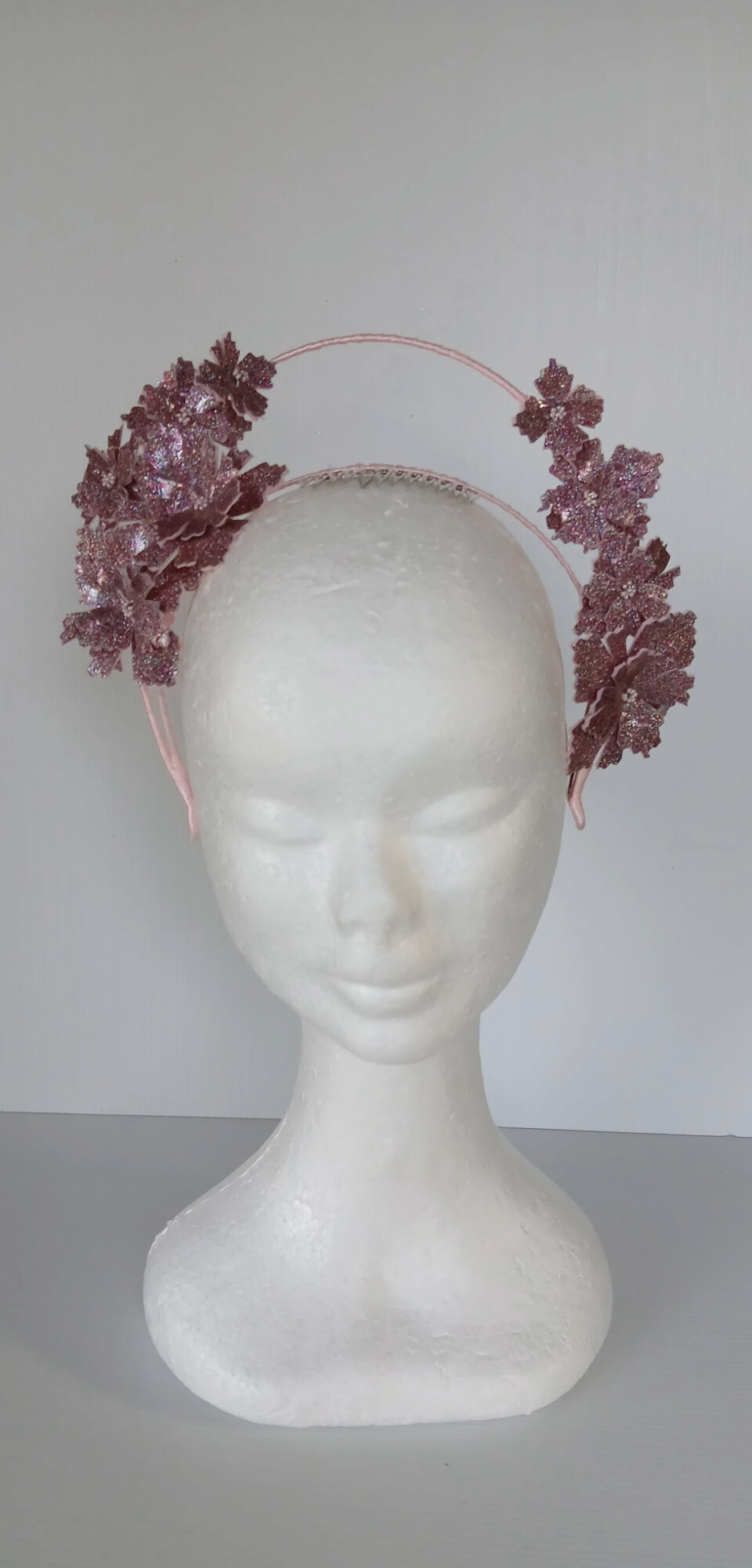A picture of a Pink Pleather Millinery Halo Crown by Melissa Rath Millinery.