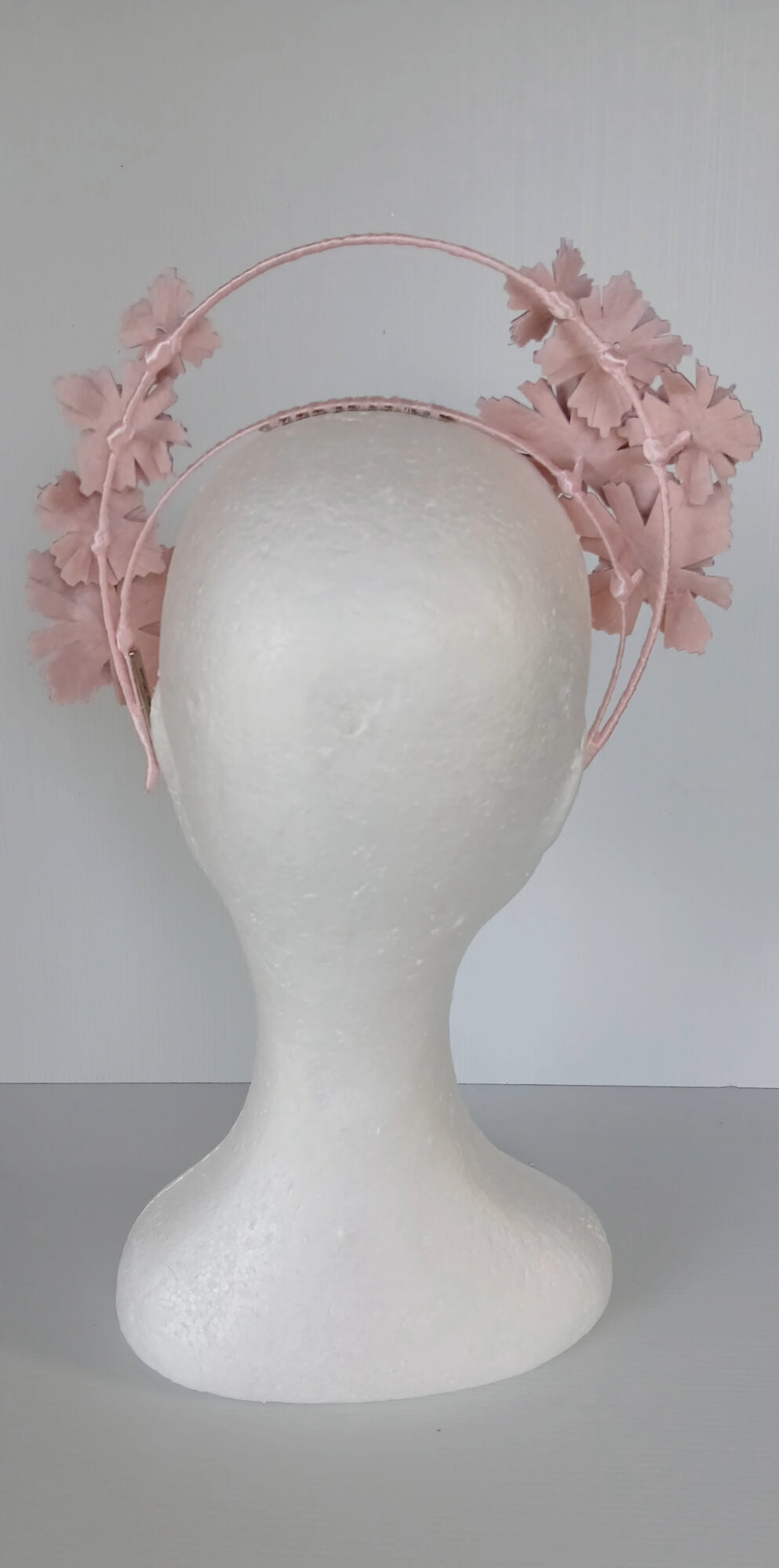 A picture of a Pink Pleather Millinery Halo Crown by Melissa Rath Millinery.