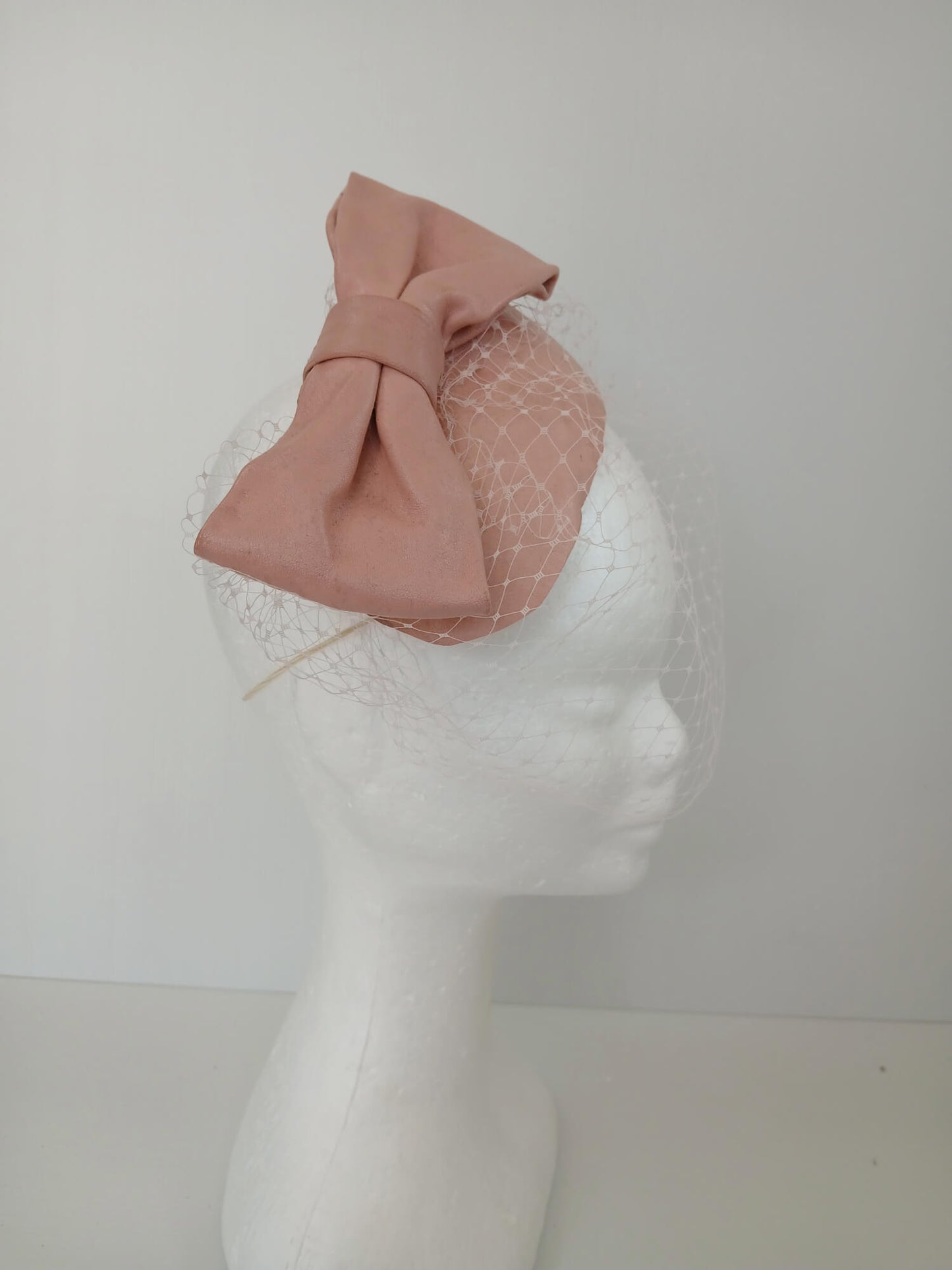 A picture of a Pink Veiled Leather Millinery Fascinator by Melissa Rath Millinery.