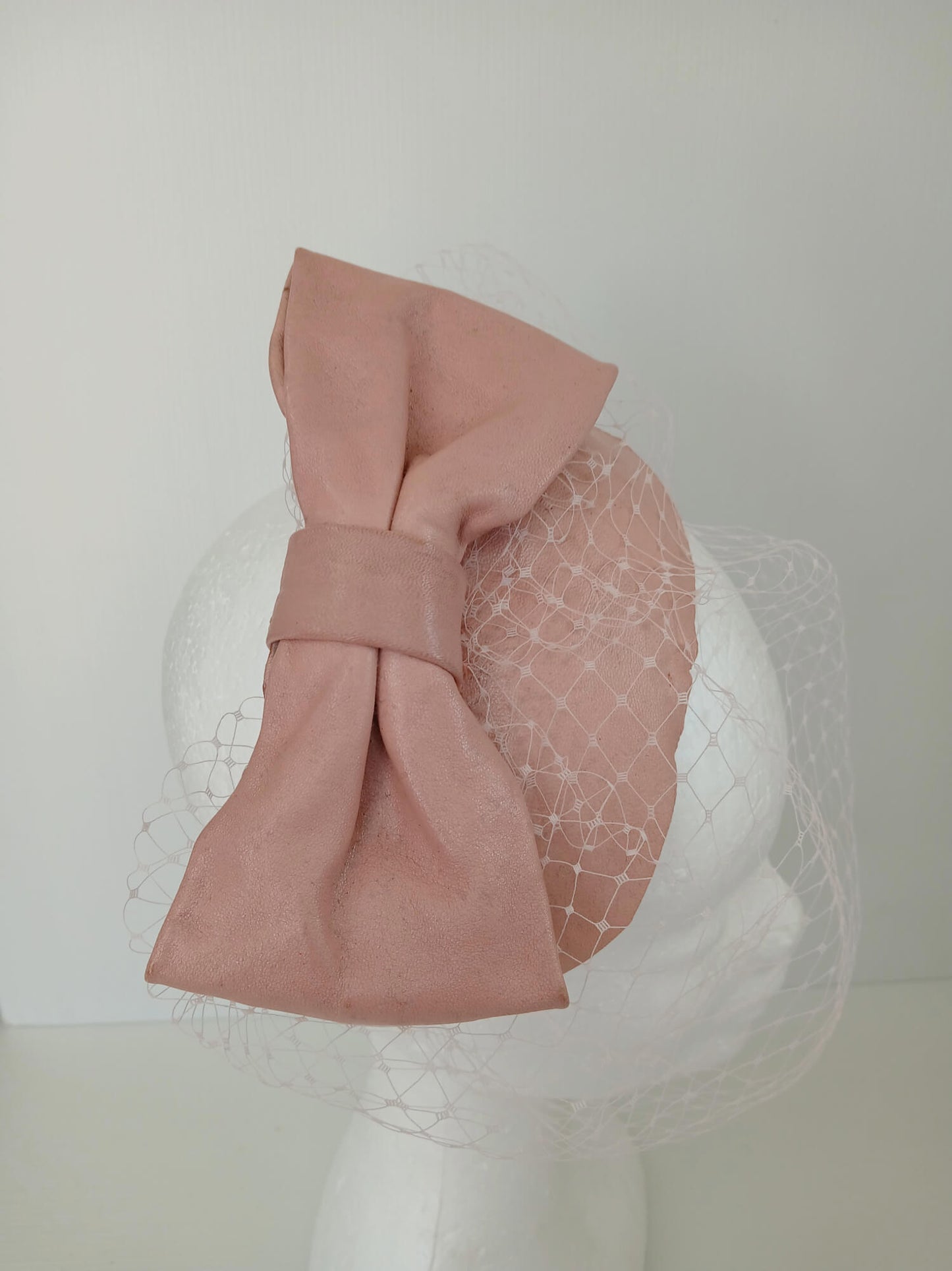 A picture of a Pink Veiled Leather Millinery Fascinator by Melissa Rath Millinery.