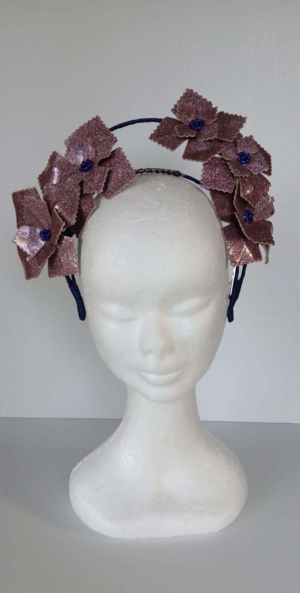 A picture of a pink and navy millinery crown.