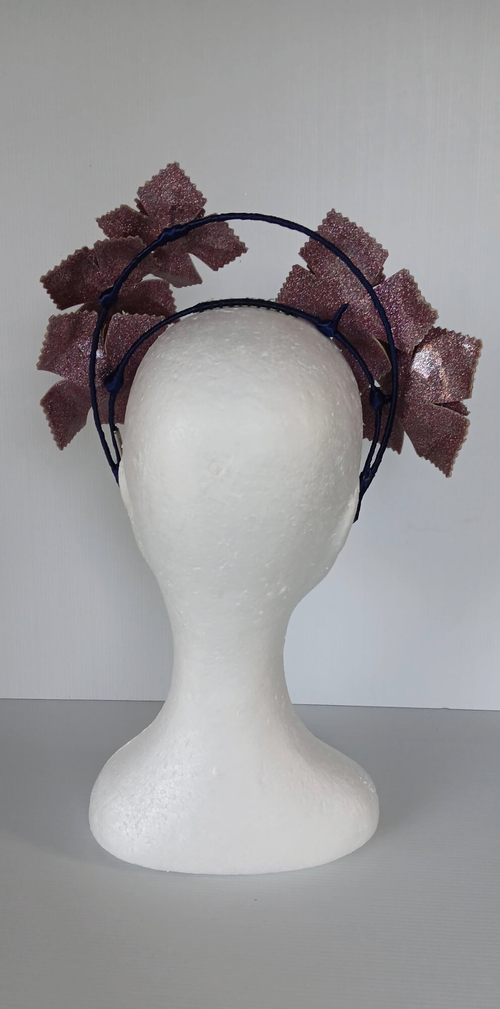 A picture of a pink and navy millinery crown.