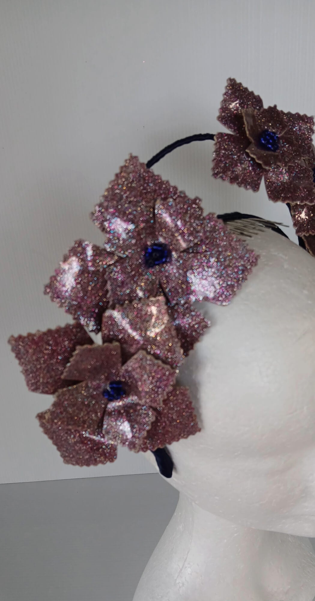 A picture of a pink and navy millinery crown.