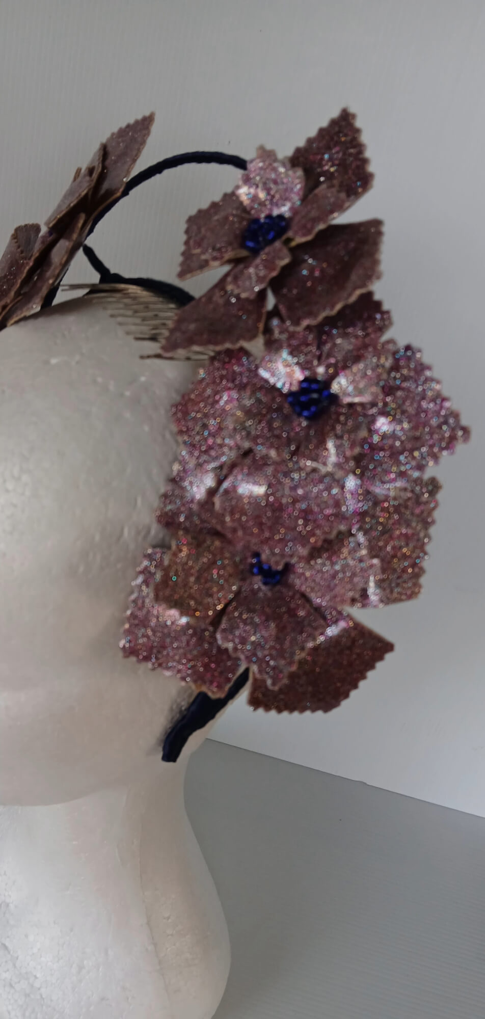 A picture of a pink and navy millinery crown.