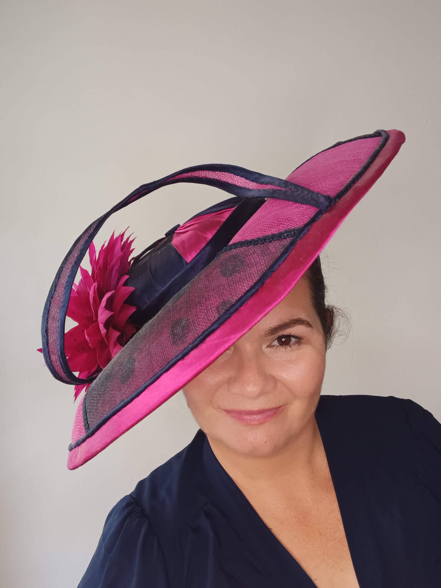 A picture of a Pink and Navy Wide Brimmed Hat by Melissa Rath Millinery.
