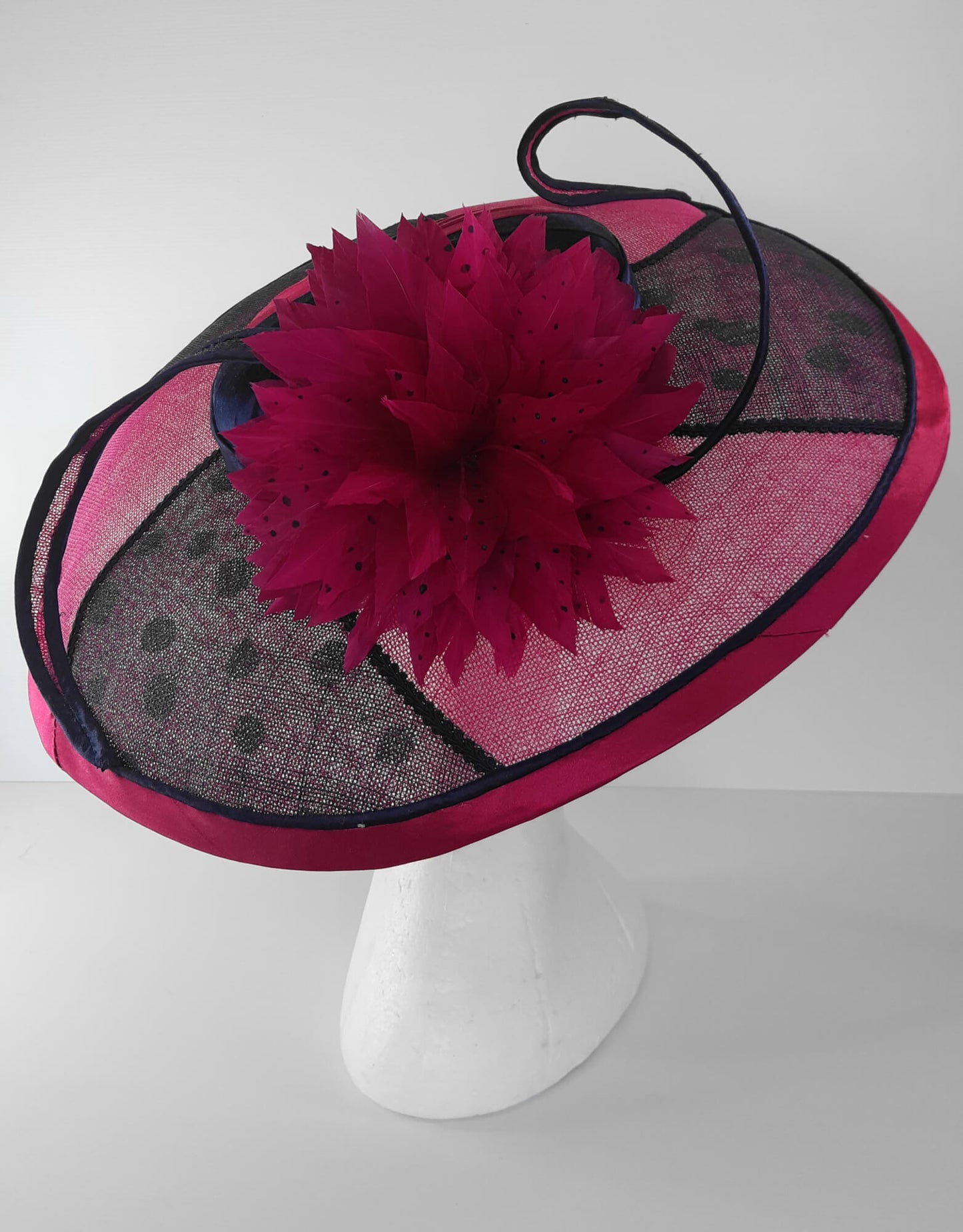 A picture of a Pink and Navy Wide Brimmed Hat by Melissa Rath Millinery.