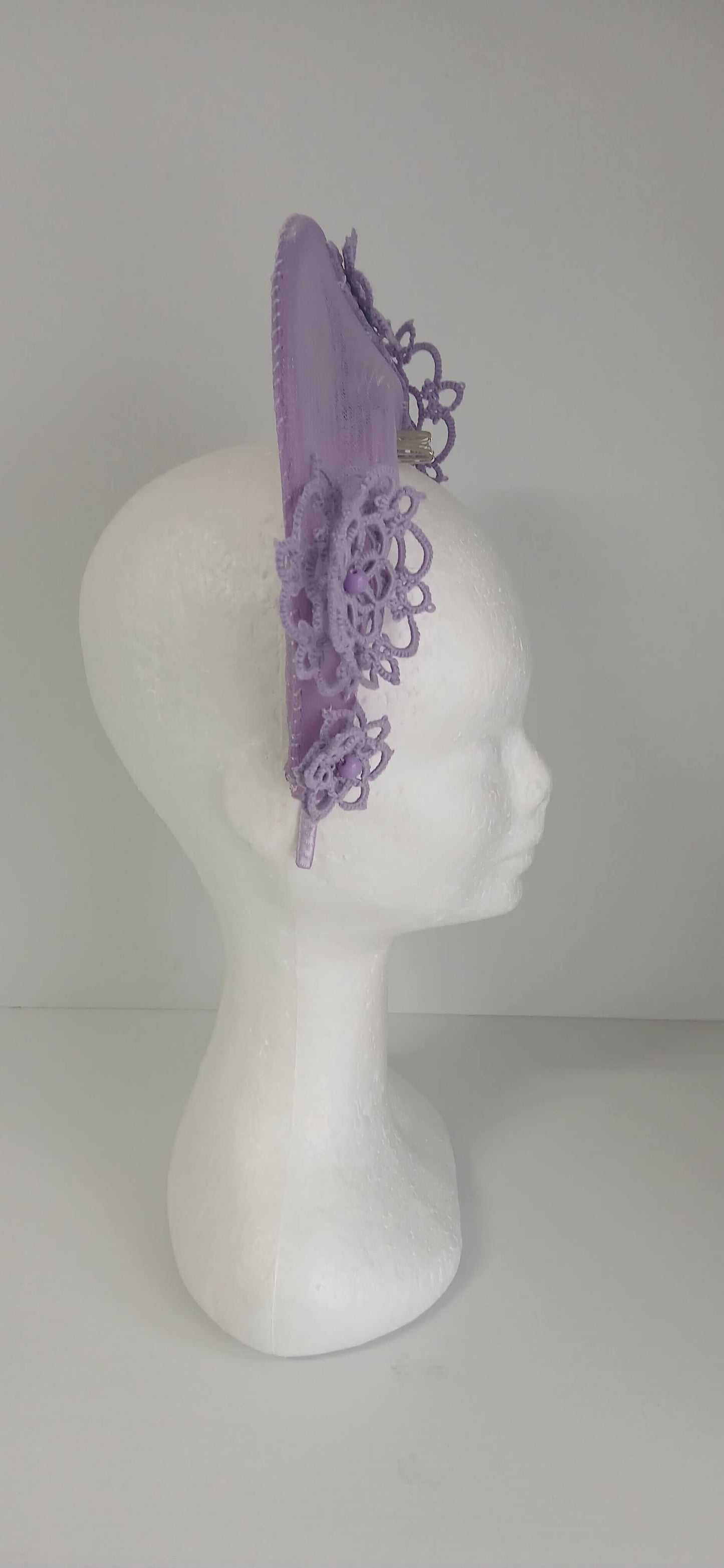 A lavender purple millinery crown by Melissa Rath Millinery, made from crinoline and trimmer with hand tatted flowers.