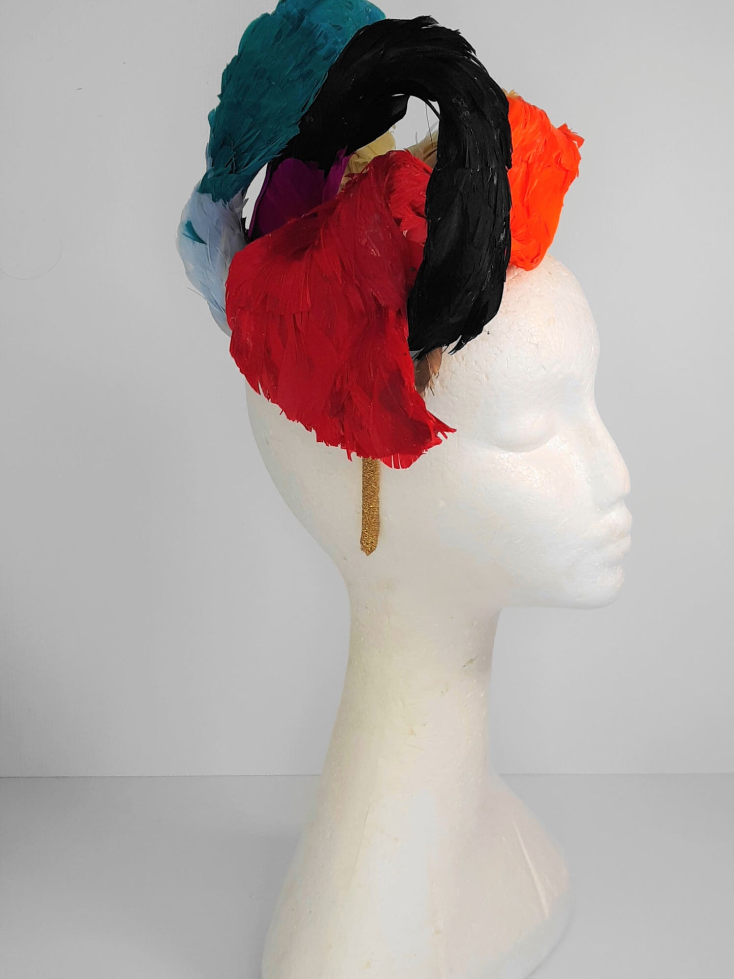 A picture of a Rainbow Feathered Millinery Fascinator by Melissa Rath Millinery.