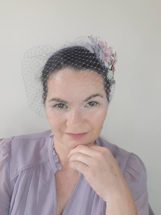 A picture of a Rainbow Veiled Millinery Headband by Melissa Rath Millinery.