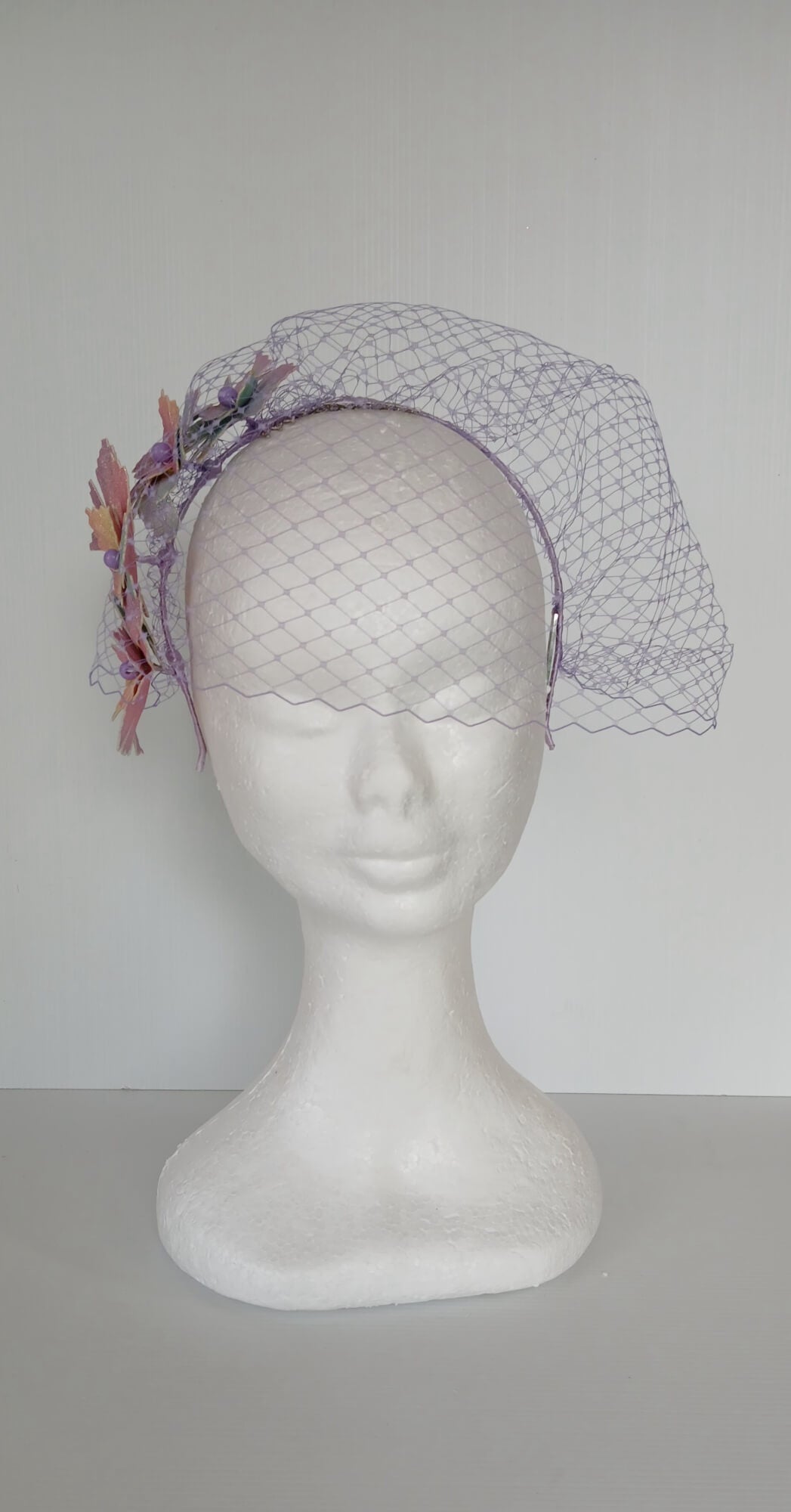 A picture of a Rainbow Veiled Millinery Headband by Melissa Rath Millinery.