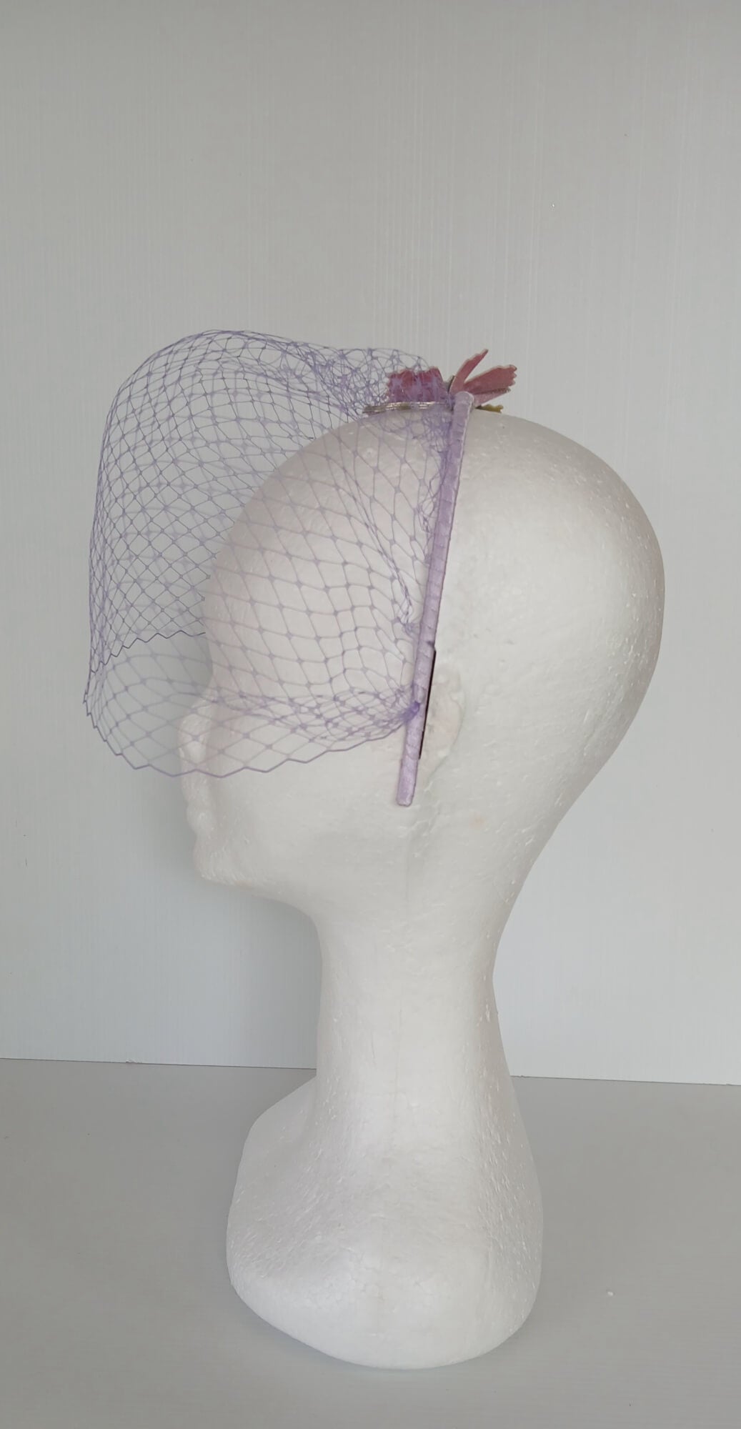 A picture of a Rainbow Veiled Millinery Headband by Melissa Rath Millinery.