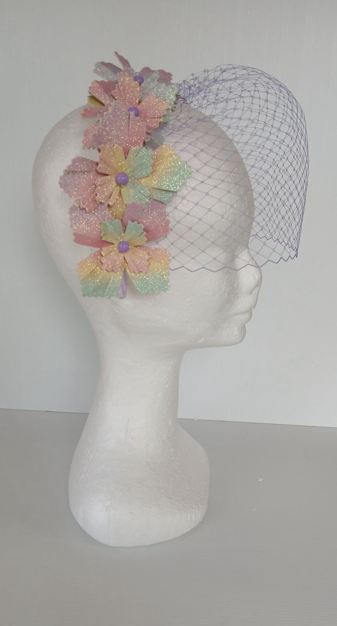 A picture of a Rainbow Veiled Millinery Headband by Melissa Rath Millinery.