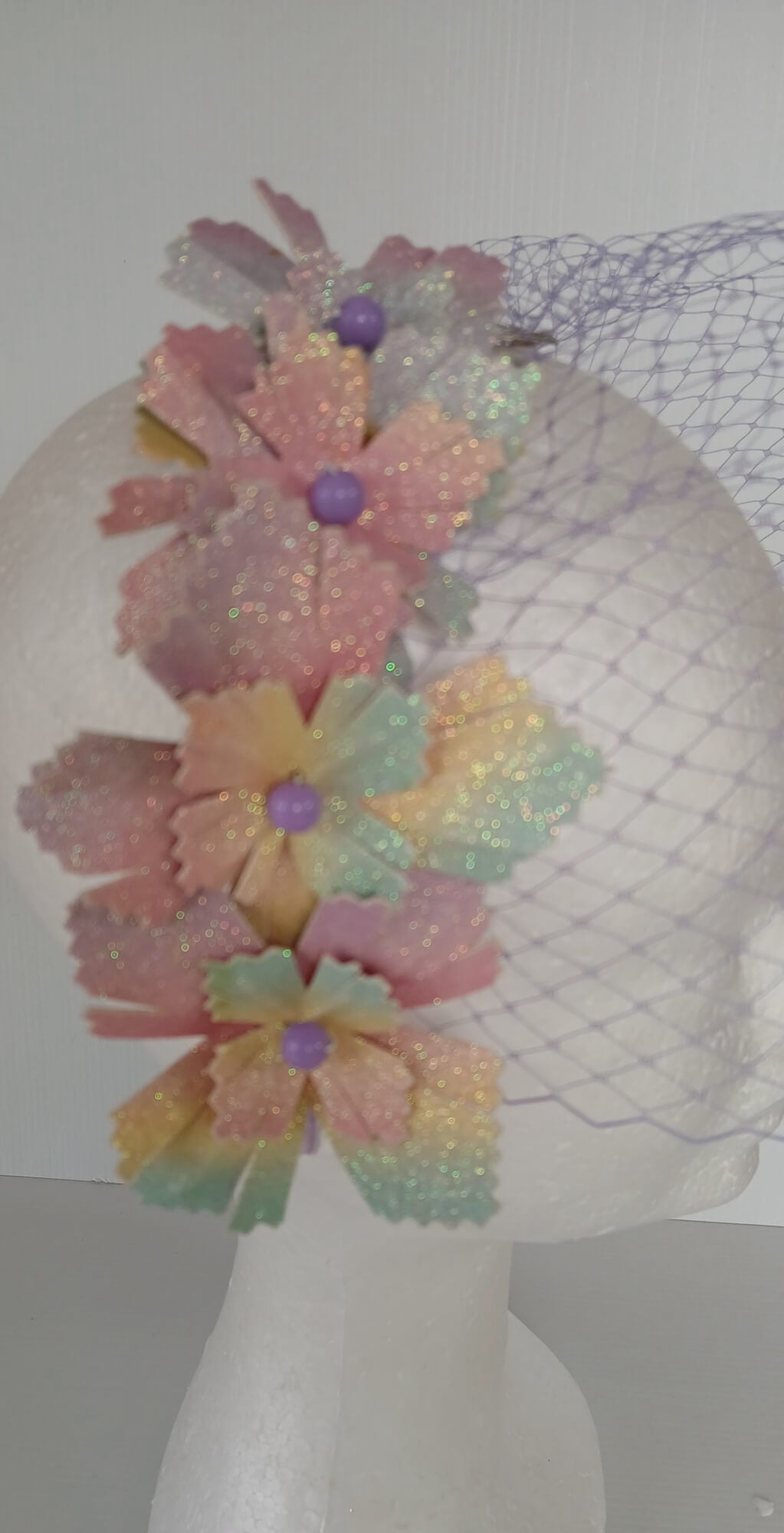 A picture of a Rainbow Veiled Millinery Headband by Melissa Rath Millinery.
