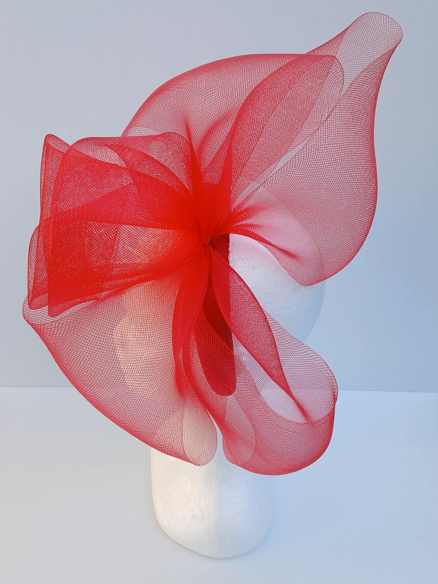 An image of a Red Padded Headband with Crinoline Bow and Rose by Melissa Rath Millinery.