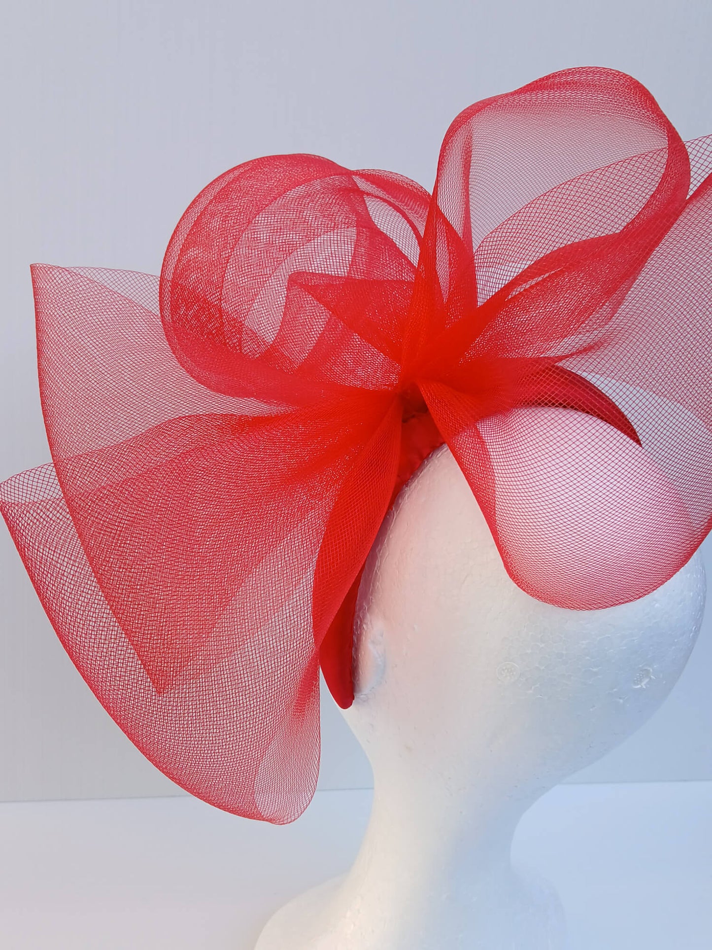 An image of a Red Padded Headband with Crinoline Bow and Rose by Melissa Rath Millinery.