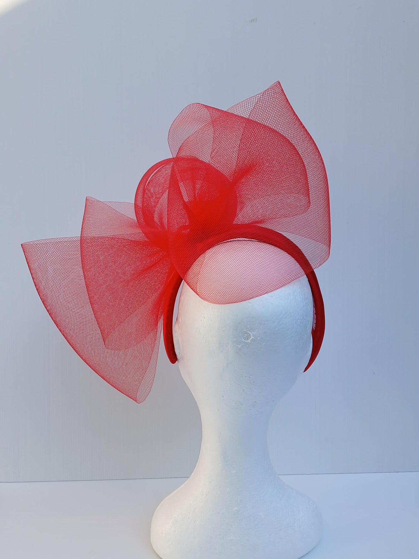 An image of a Red Padded Headband with Crinoline Bow and Rose by Melissa Rath Millinery.