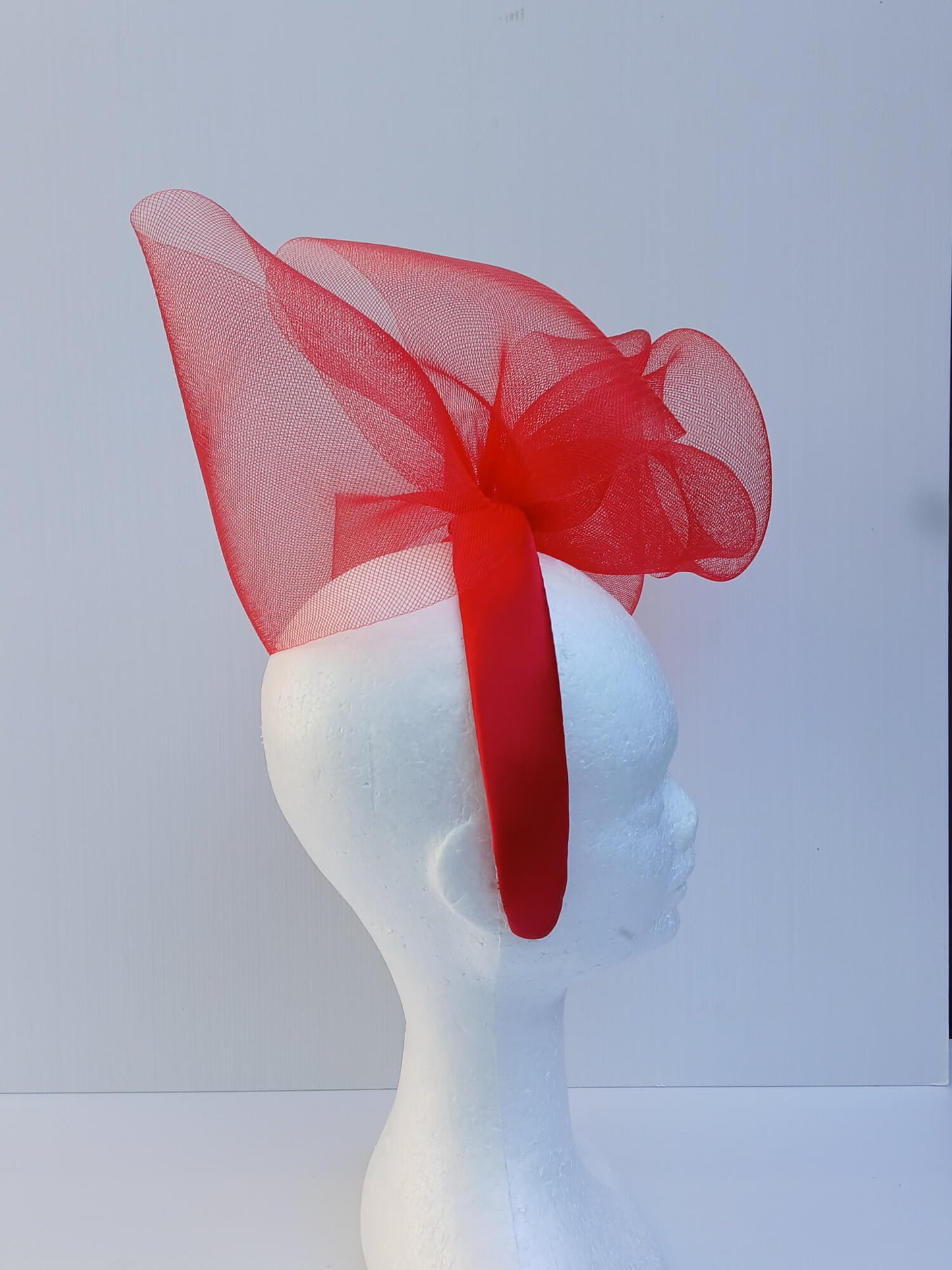 An image of a Red Padded Headband with Crinoline Bow and Rose by Melissa Rath Millinery.