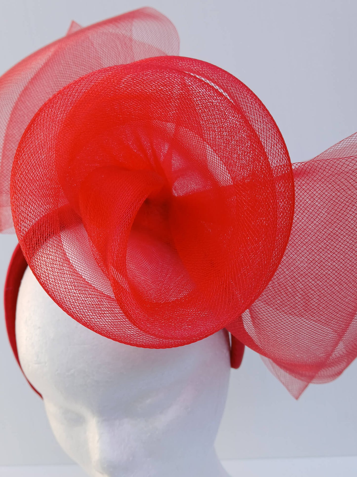 An image of a Red Padded Headband with Crinoline Bow and Rose by Melissa Rath Millinery.