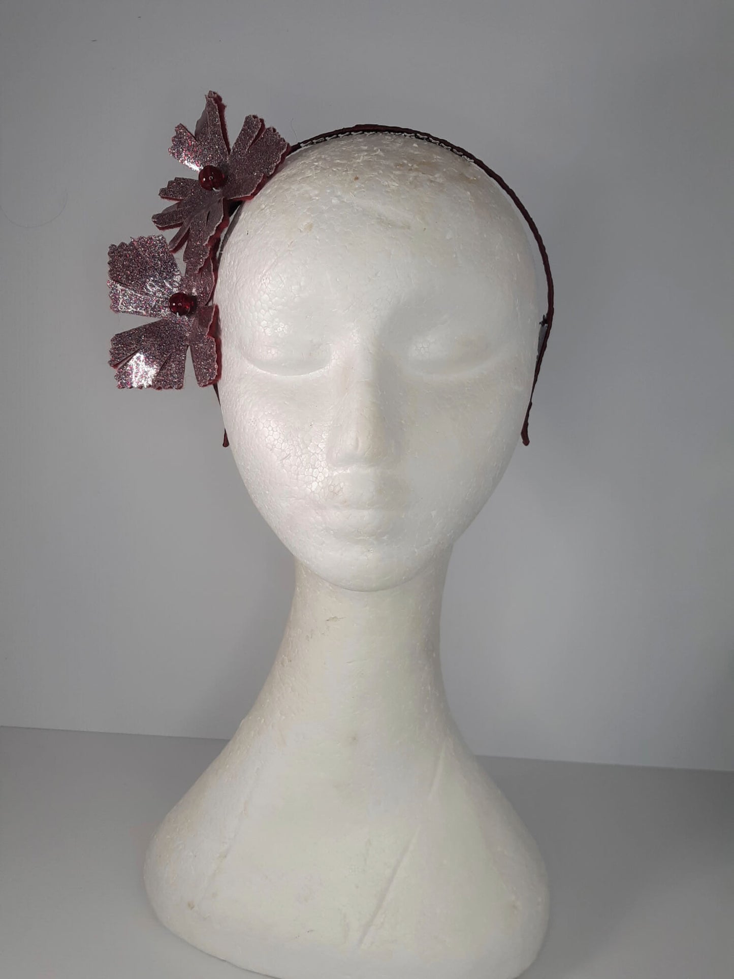 A picture of a red headband in pleather and felt by Melissa Rath Millinery.