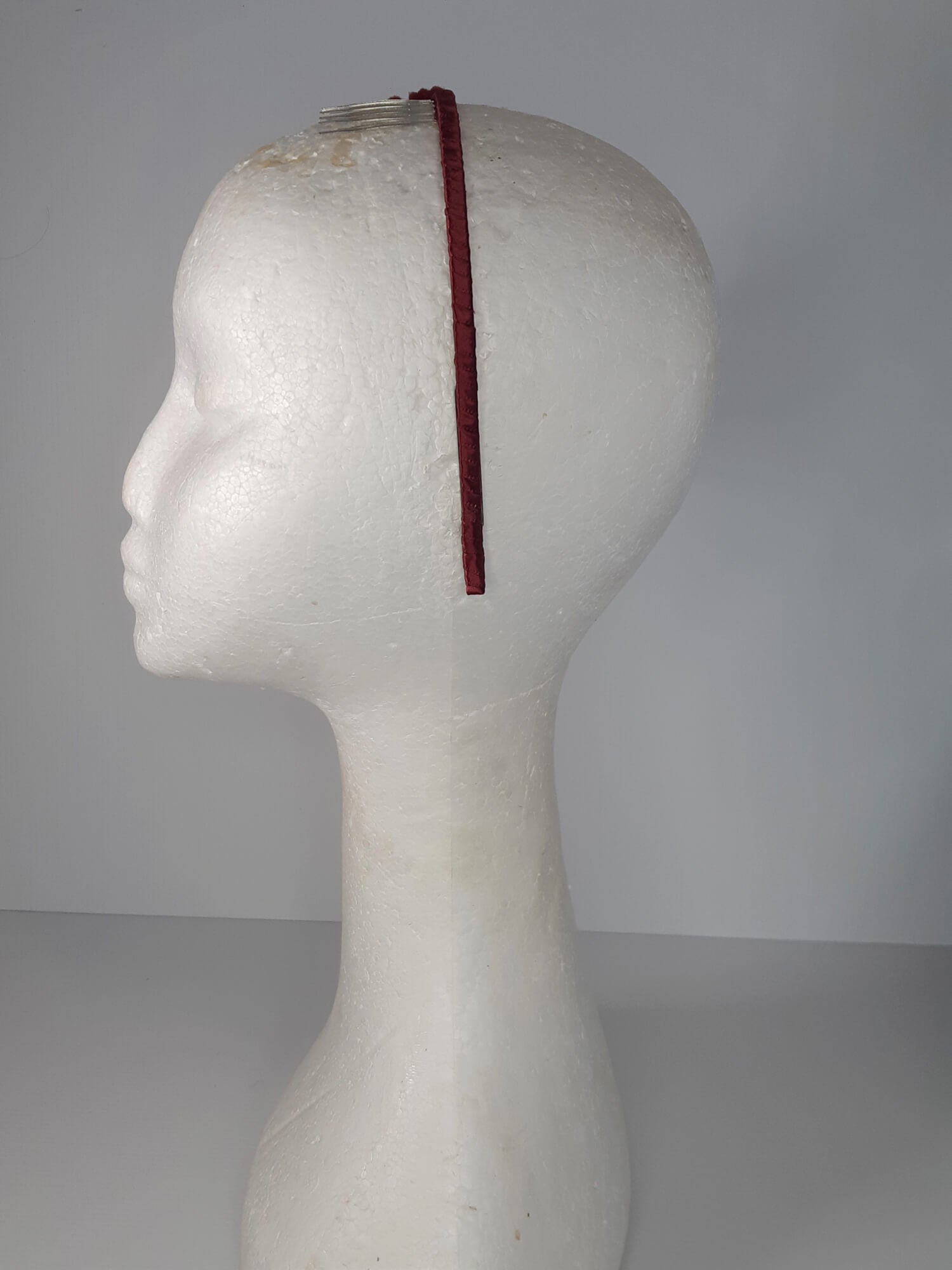 A picture of a red headband in pleather and felt by Melissa Rath Millinery.