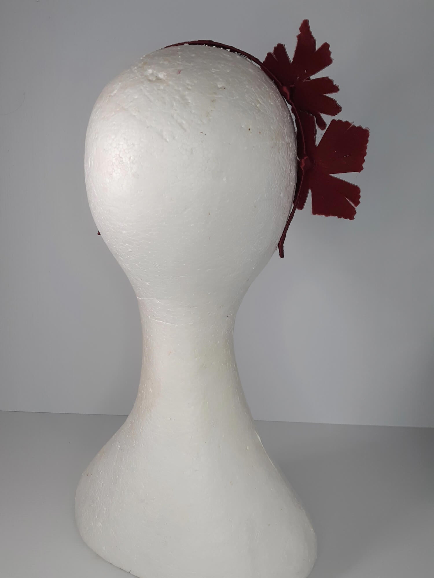 A picture of a red headband in pleather and felt by Melissa Rath Millinery.